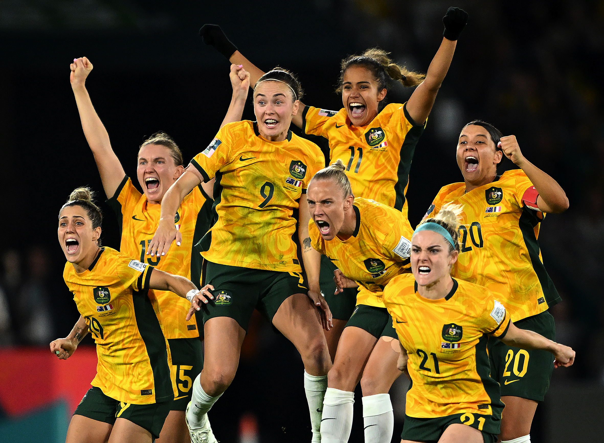 Matildas players jump in celebration.