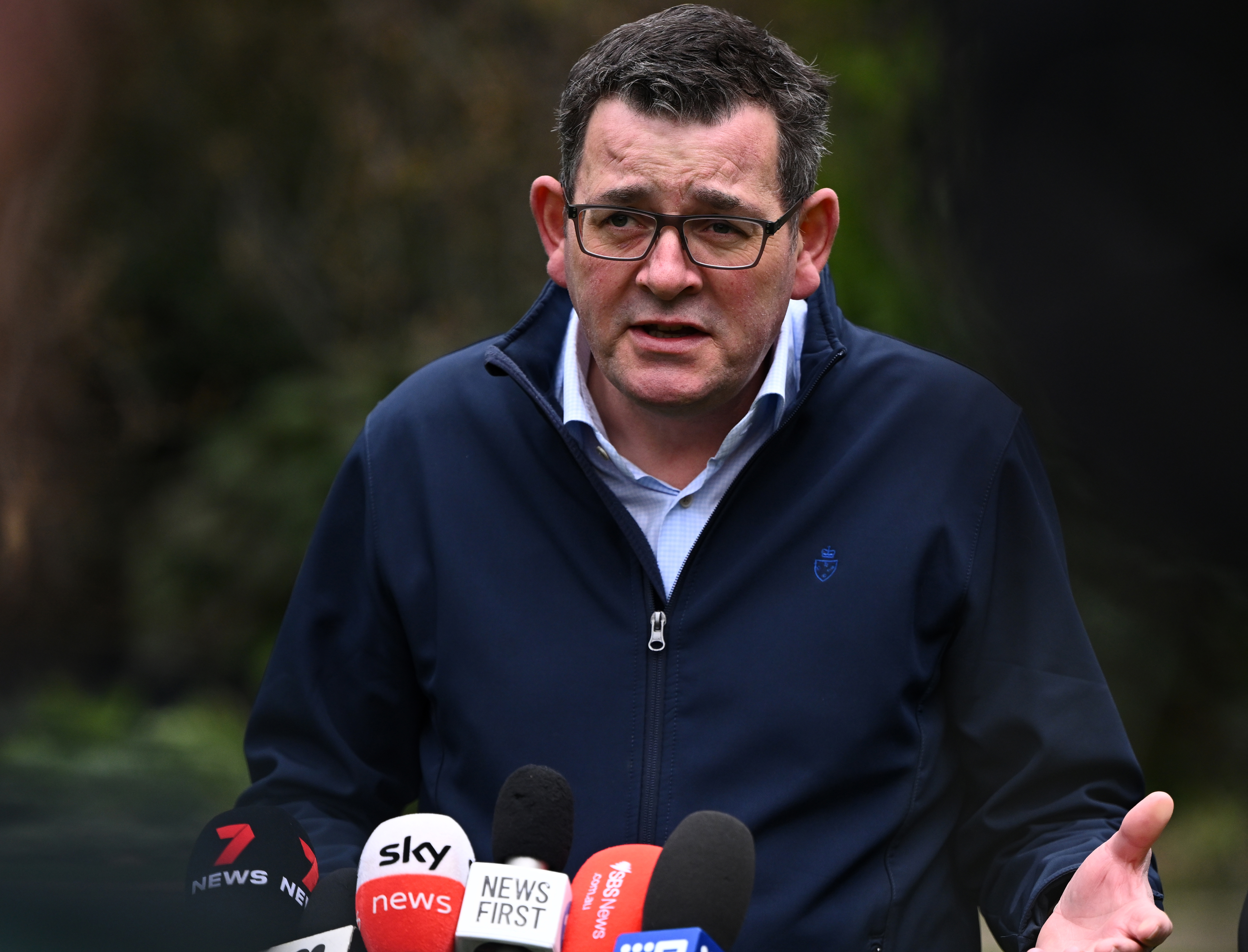 Premier Daniel Andrews speaking at an outdoor press conference.