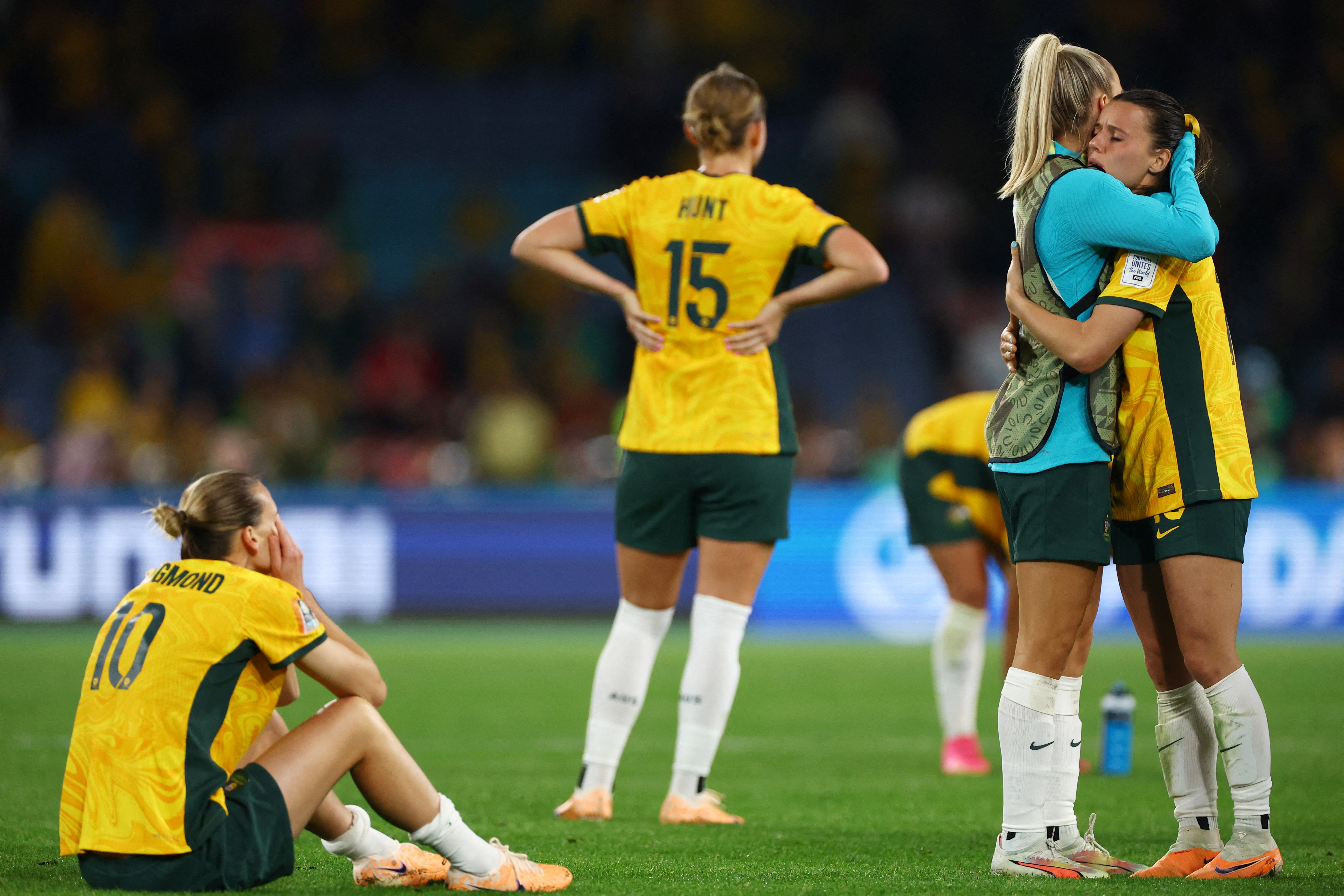 Footballers looking dejected on the field.