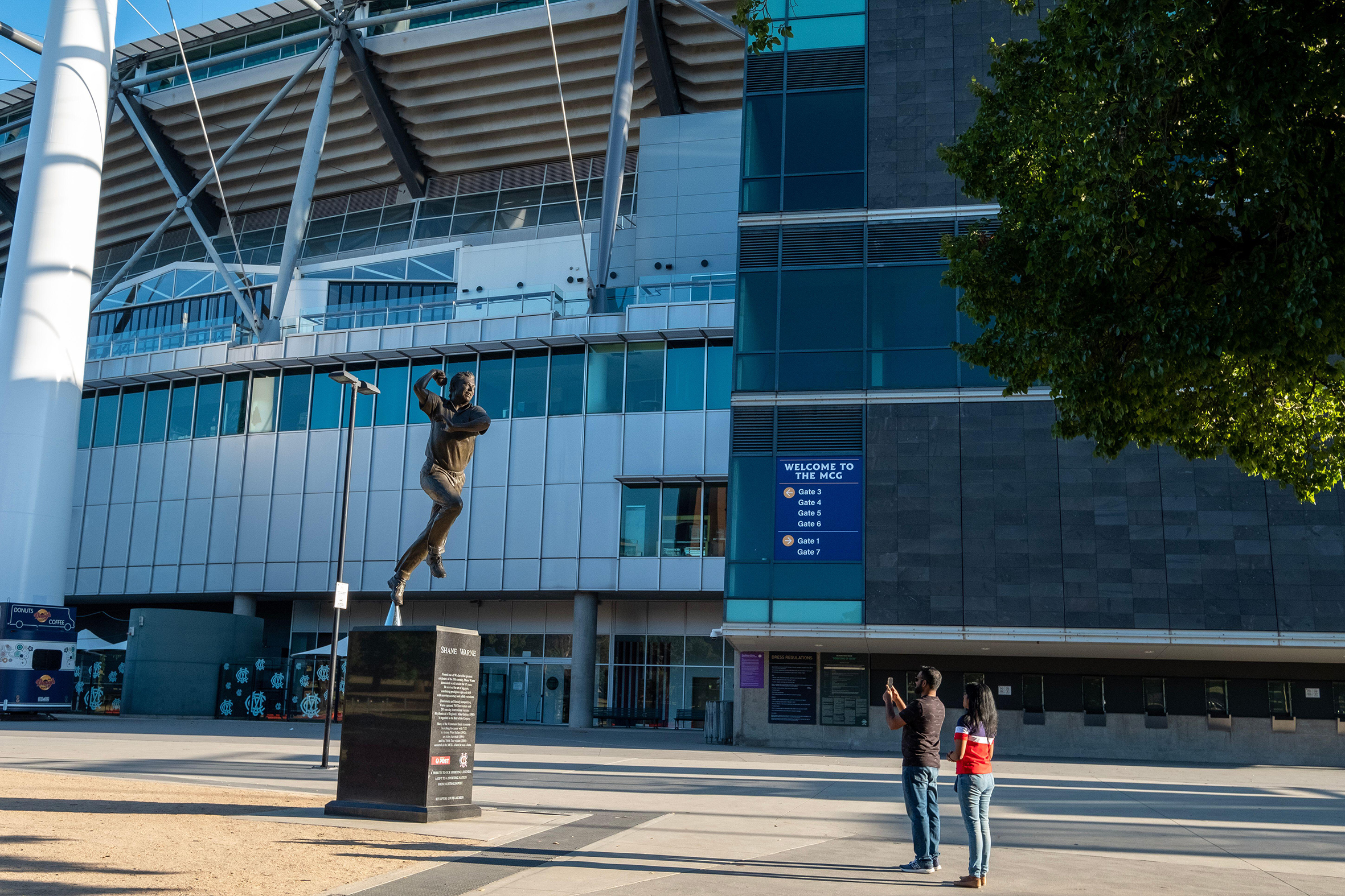A statue of Shane Warne outside the MCG and the Australian Sports Museum. 