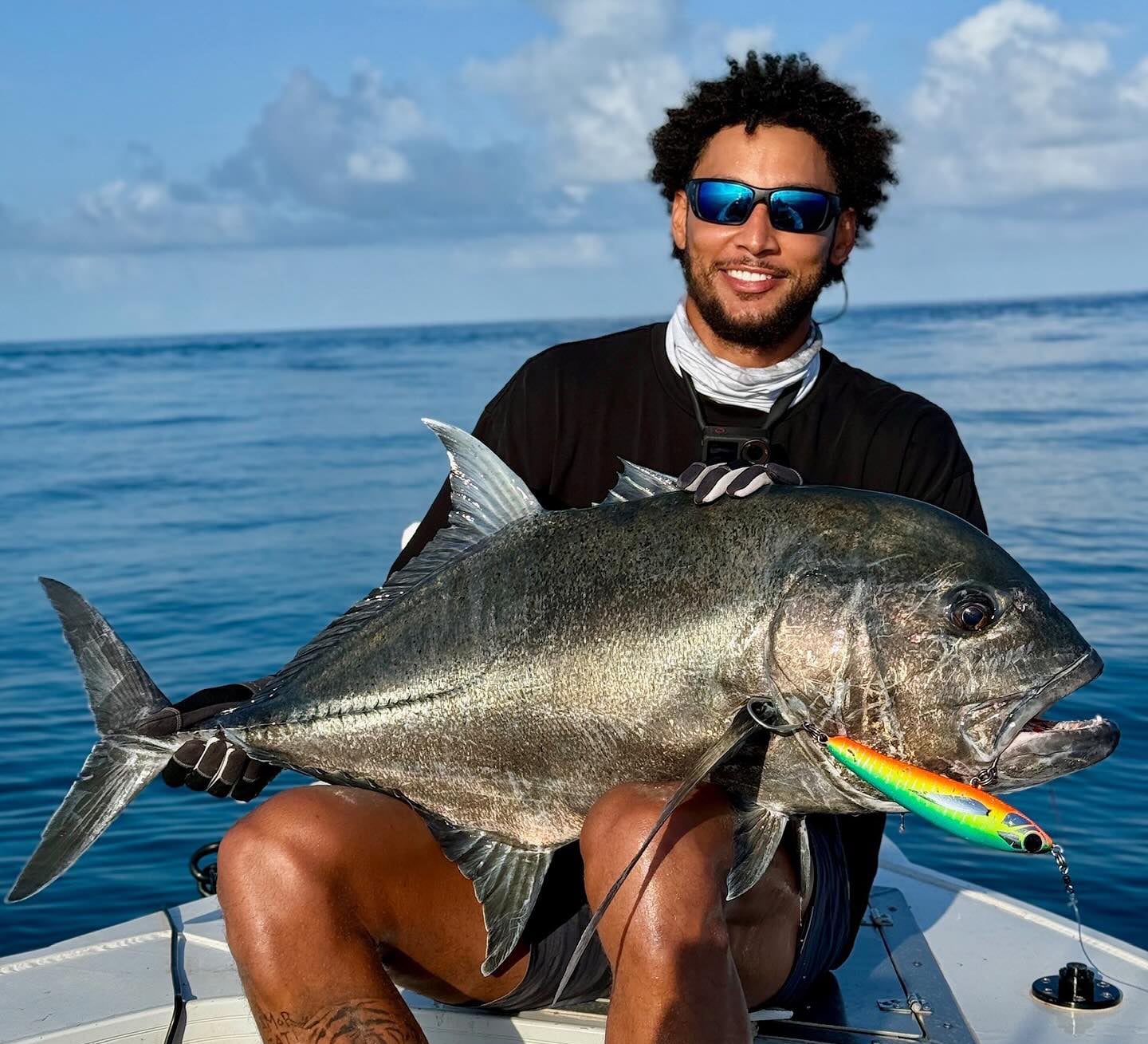 Ben Simmons holding a fish.