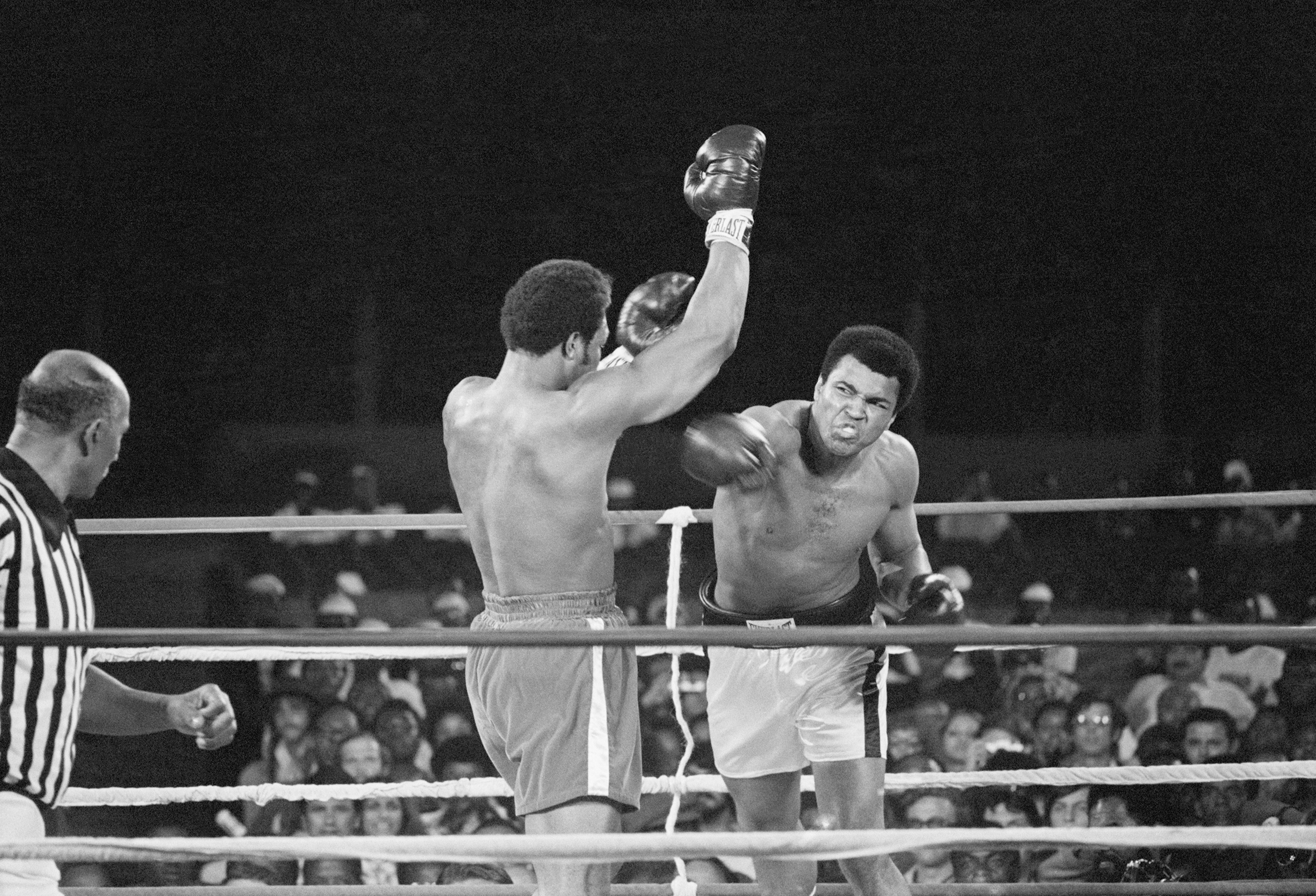 Muhammad Ali throws a punch at George Foreman.