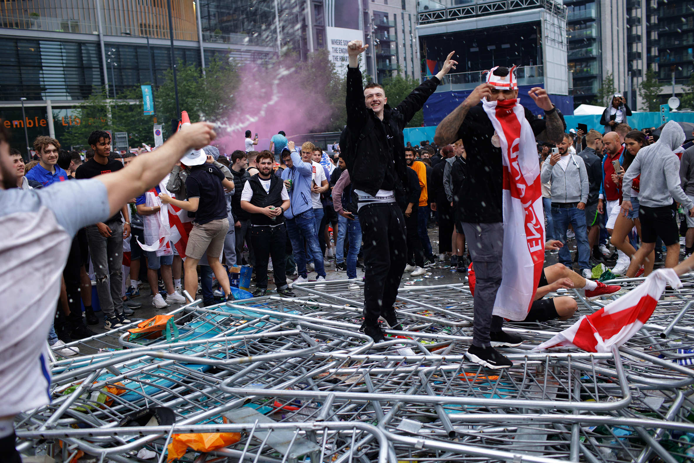 England supporters trample on barricades outside Wembley Stadium ahead of the Euro 2020 final.