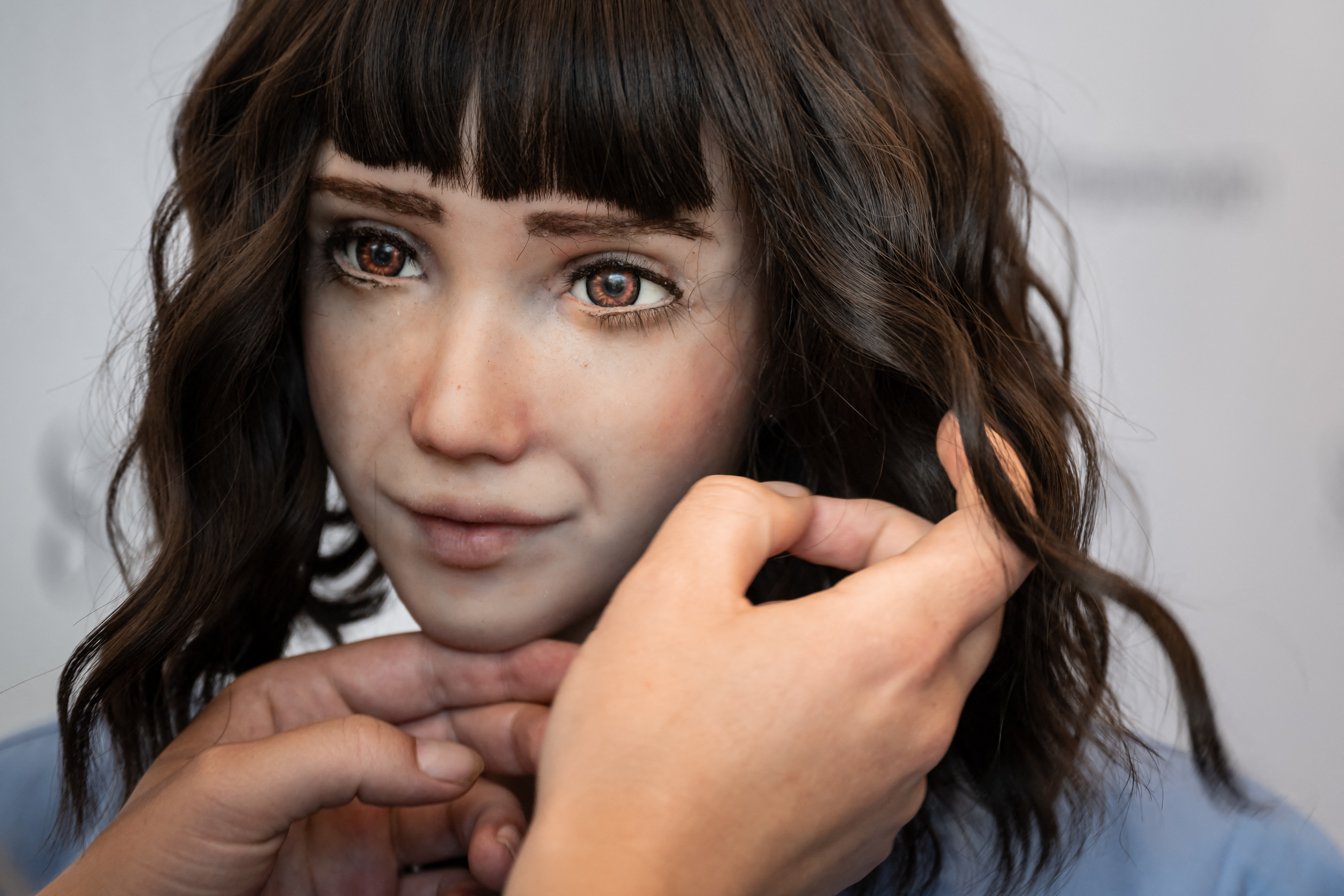 A robot with facial features that resemble a young woman.