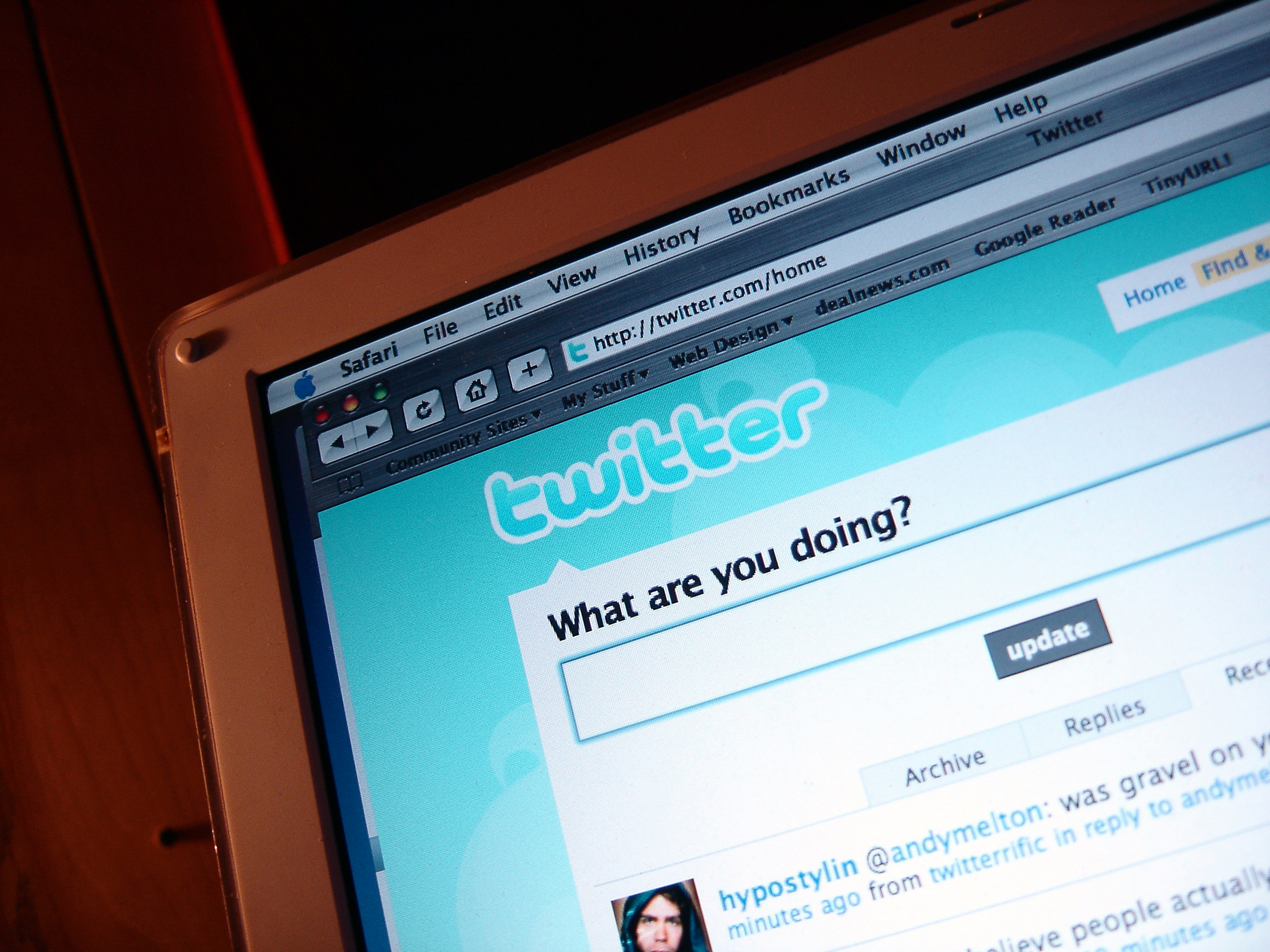 A computer screen shows an early desktop version of the Twitter site; the blue and white Twitter logo is curly and there's a text prompt above the tweet box that says, 'What are you doing?'