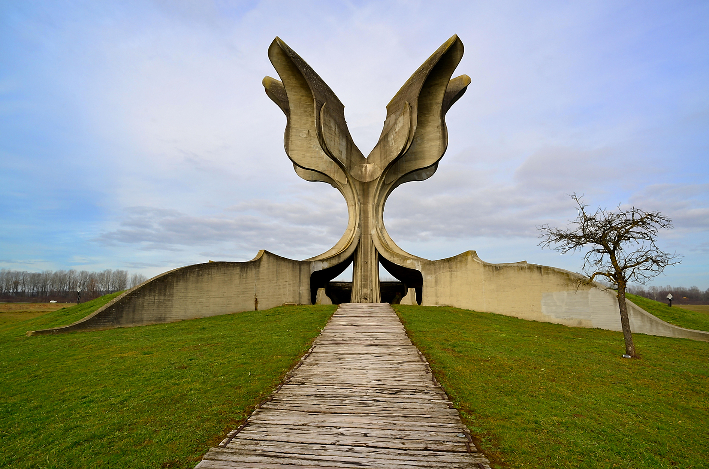 A surrealist monument standing tall over parkland.