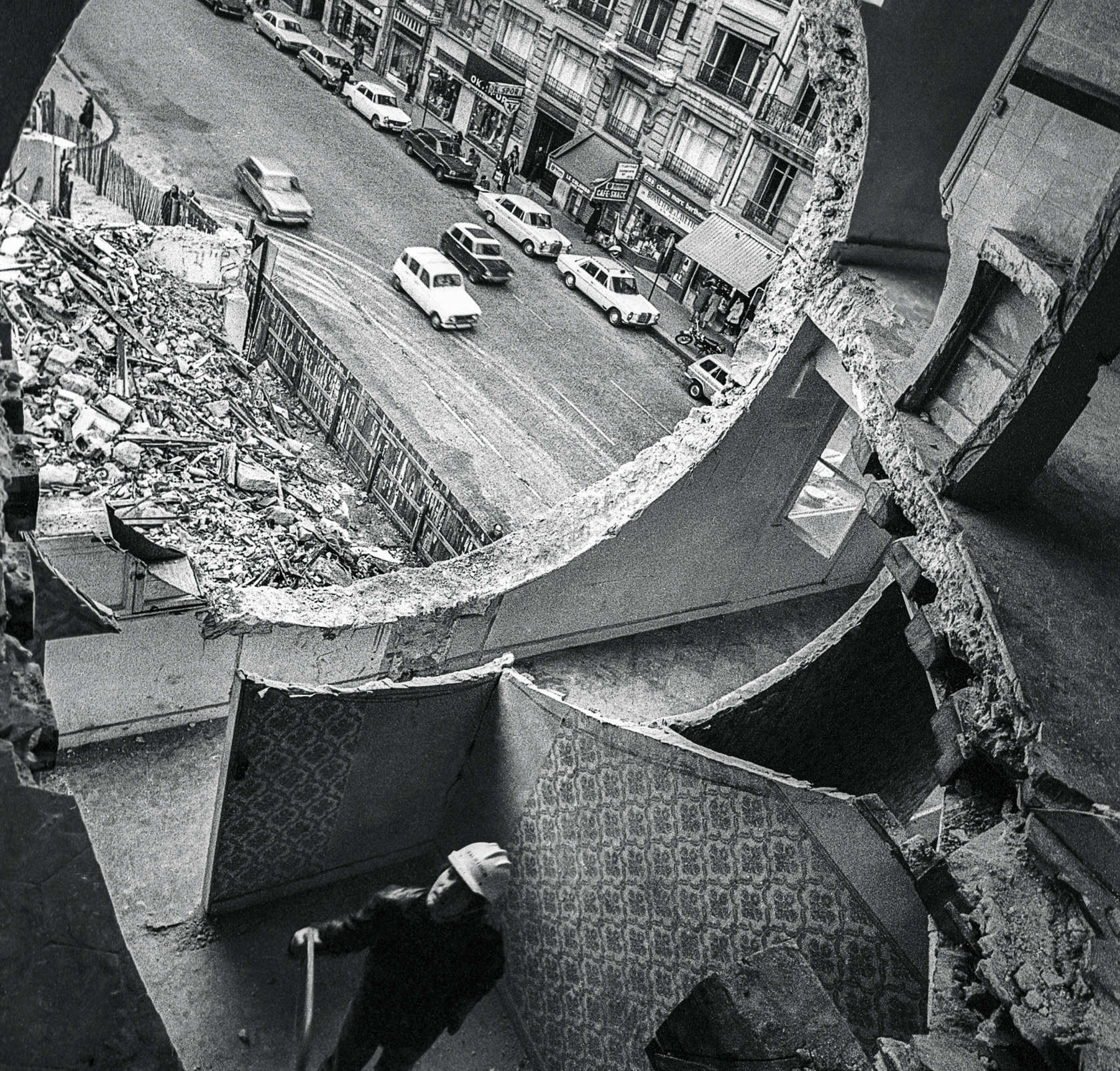 The view of a Parisian street from inside the ruins of a building.