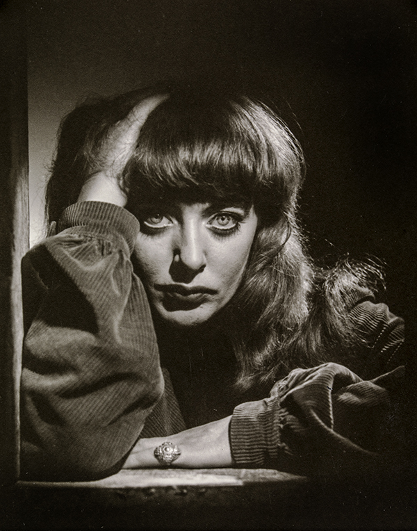 Portrait image of a young woman with piercing eyes and a fringe cut.