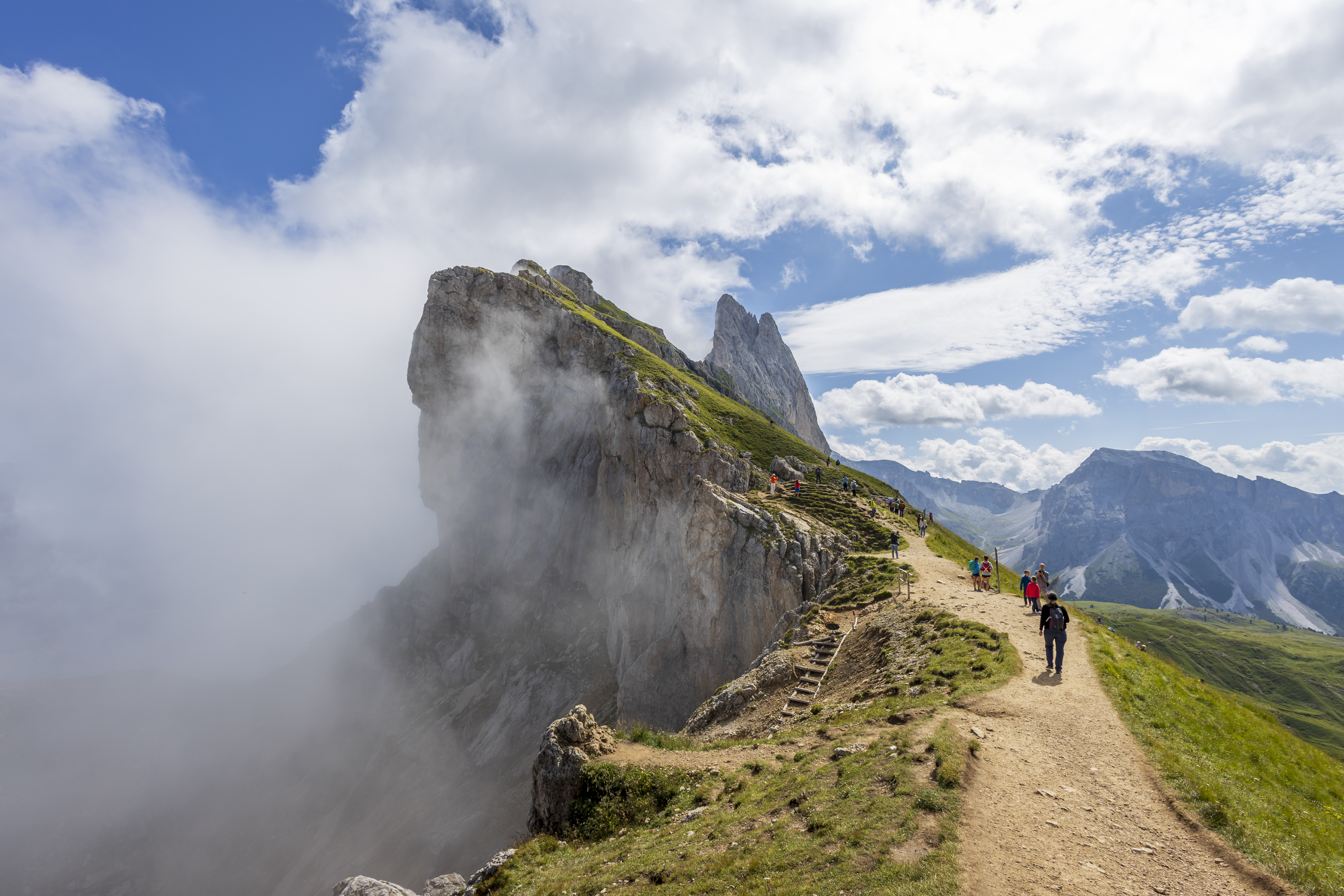 Hikers on the ridge of a mountain in the Dolomites.