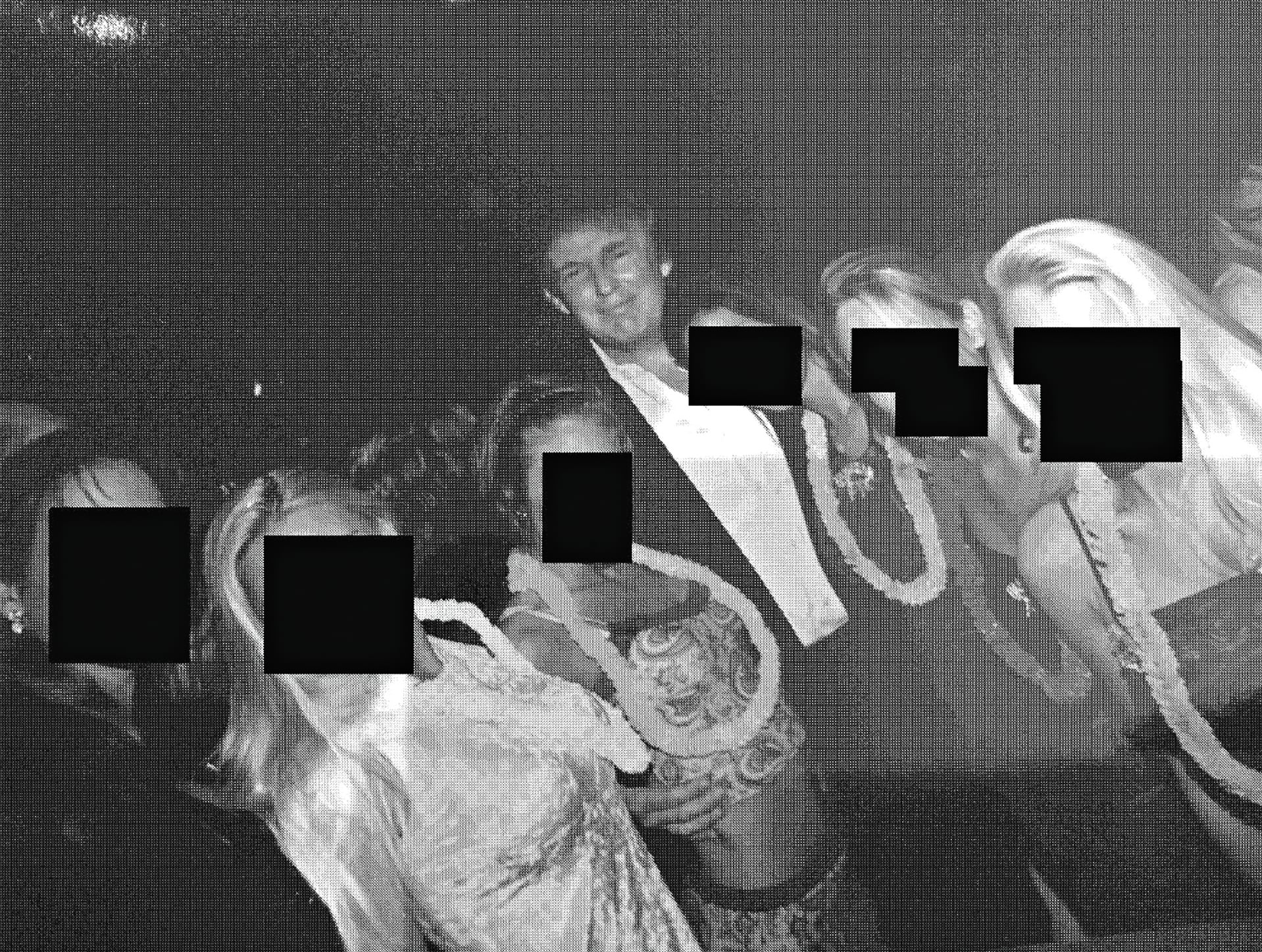 Donald Trump poses for a photo with several women who have their faces redacted.