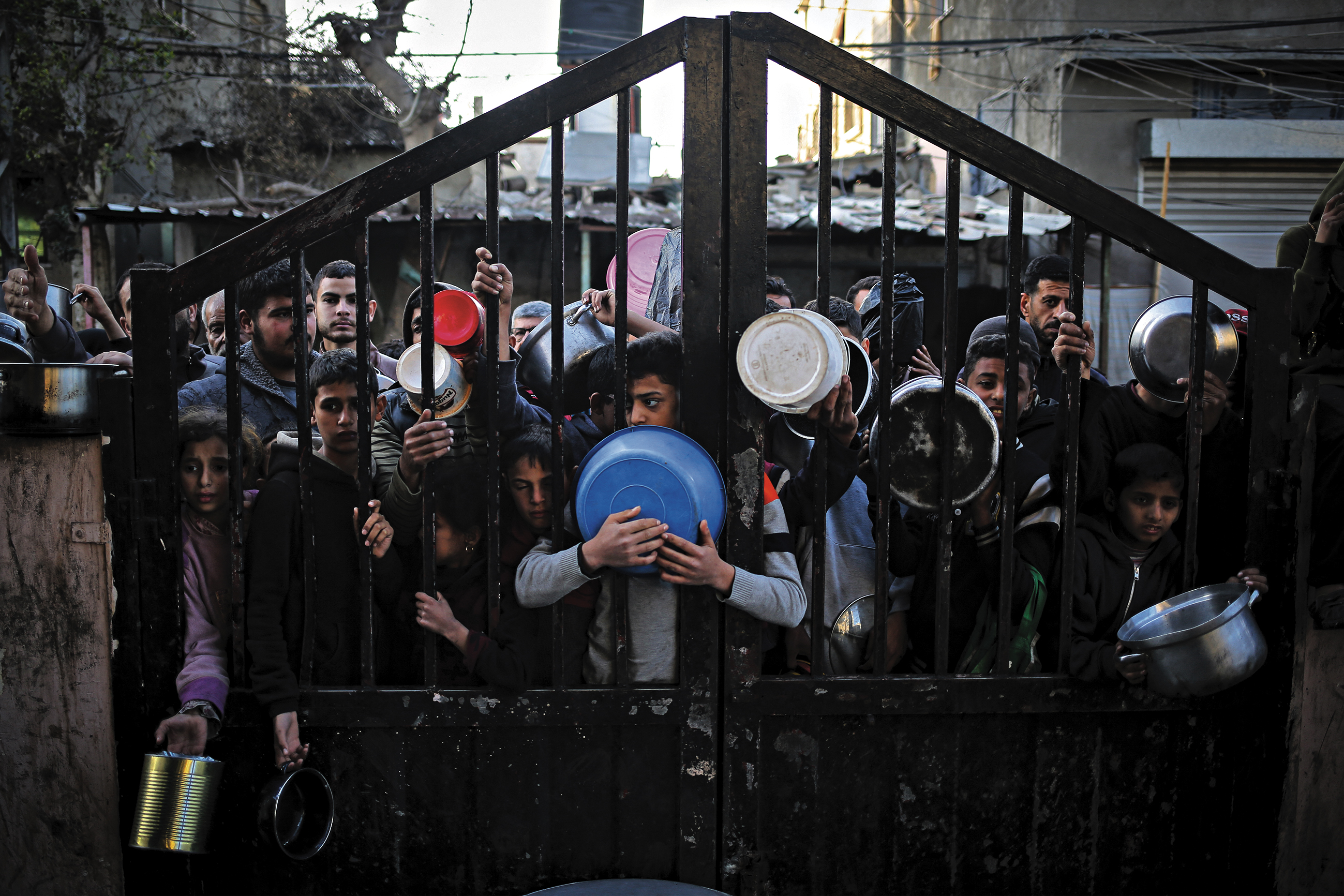 Displaced Palestinians in Rafah gather to collect food donated by a charity before a fast-breaking evening meal on the first day of Ramadan last Sunday. 