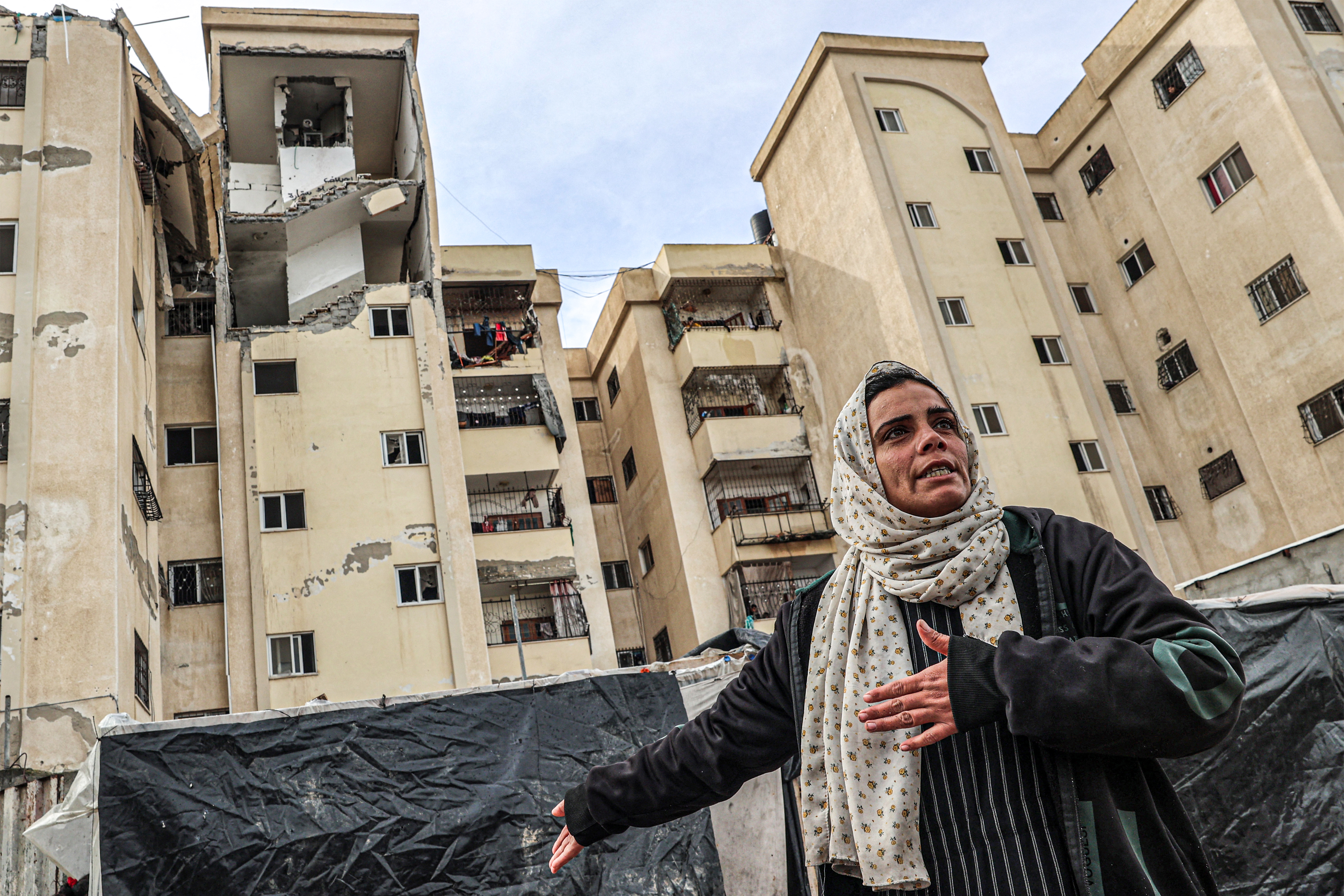 A woman outside a damaged building following Israeli bombings in Rafah. 