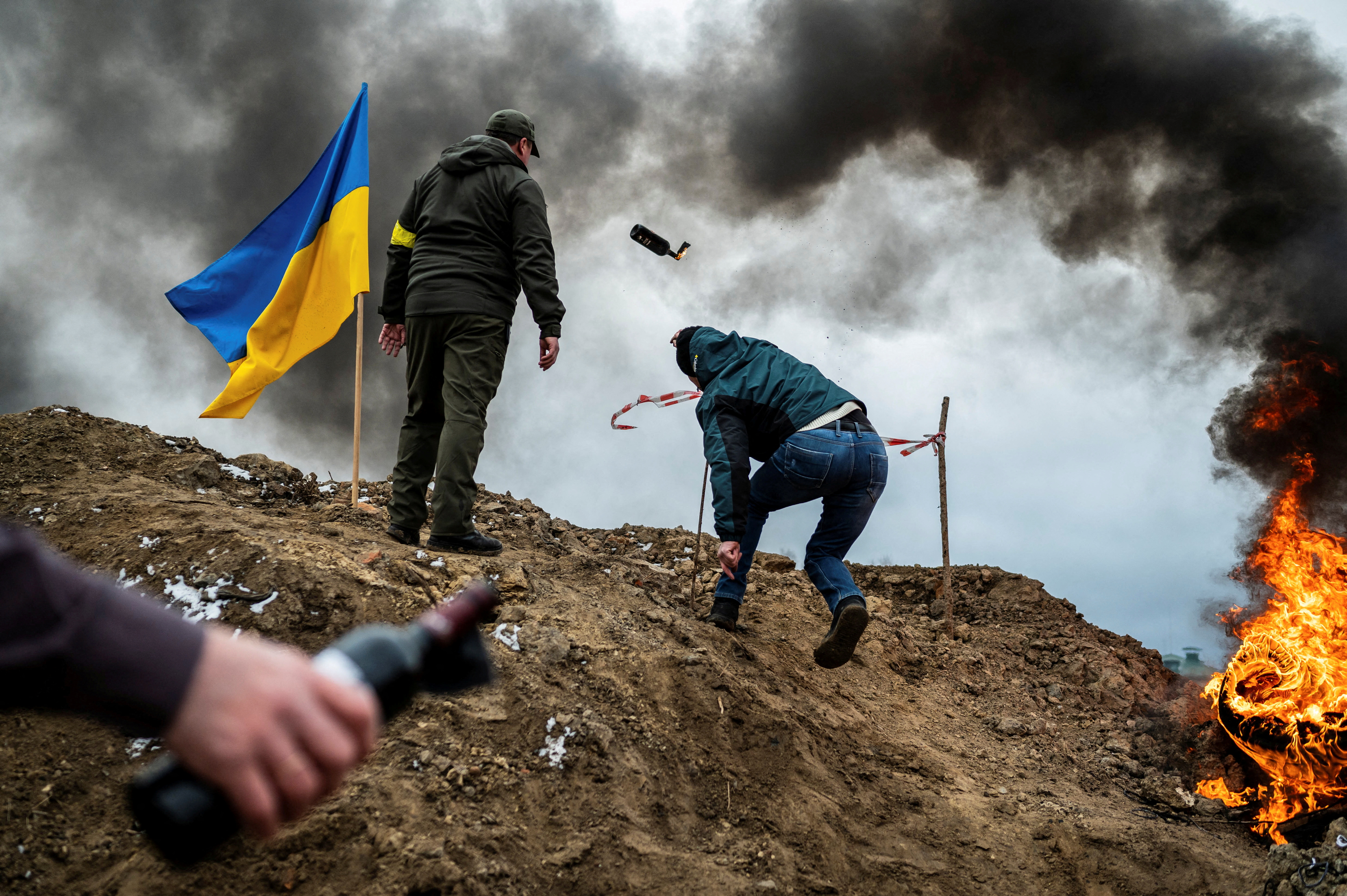 A Ukrainian civilian throws a Molotov cocktail
