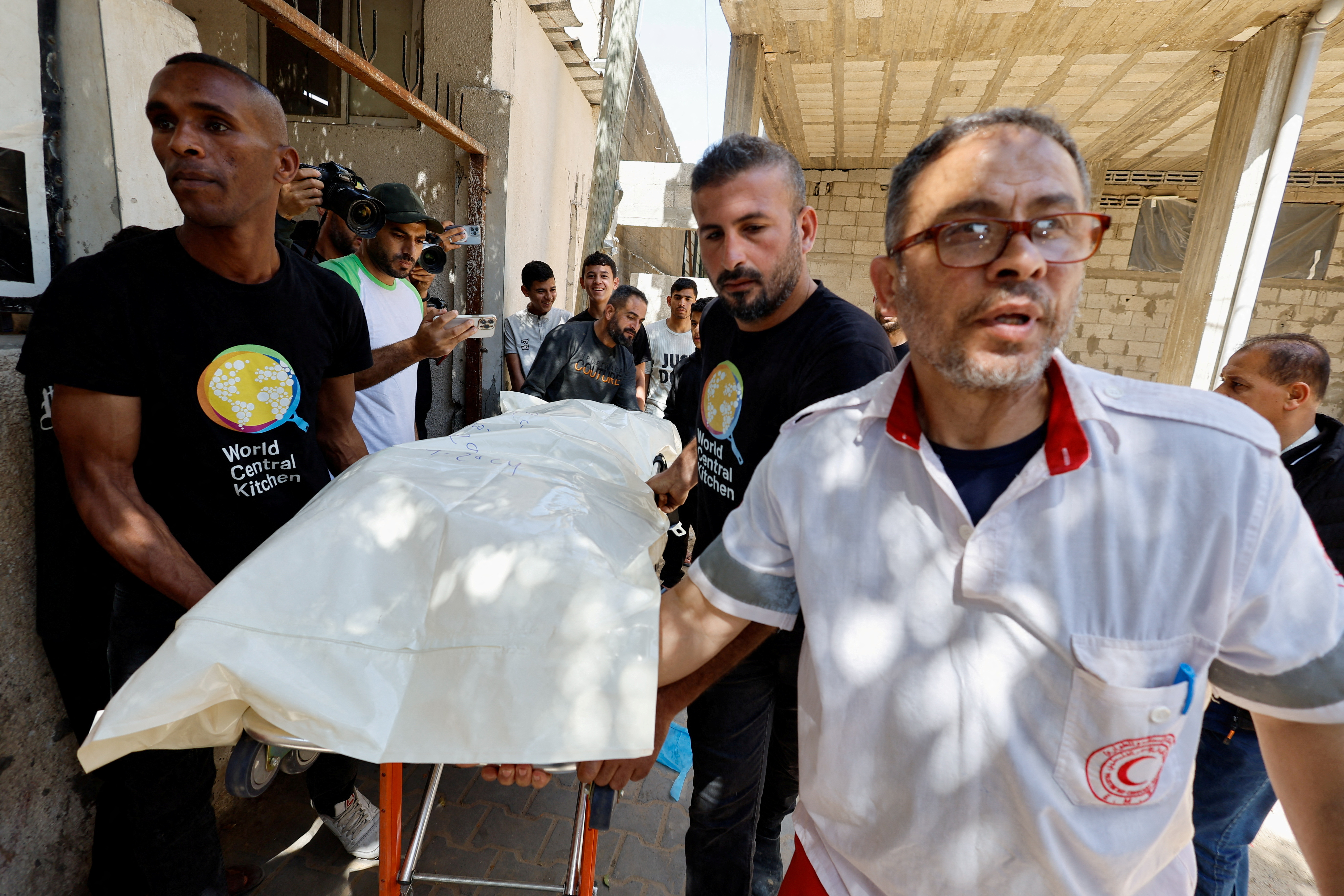 The body of one of the World Central Kitchen workers killed in an Israeli air strike is taken to be transported away from Rafah.
