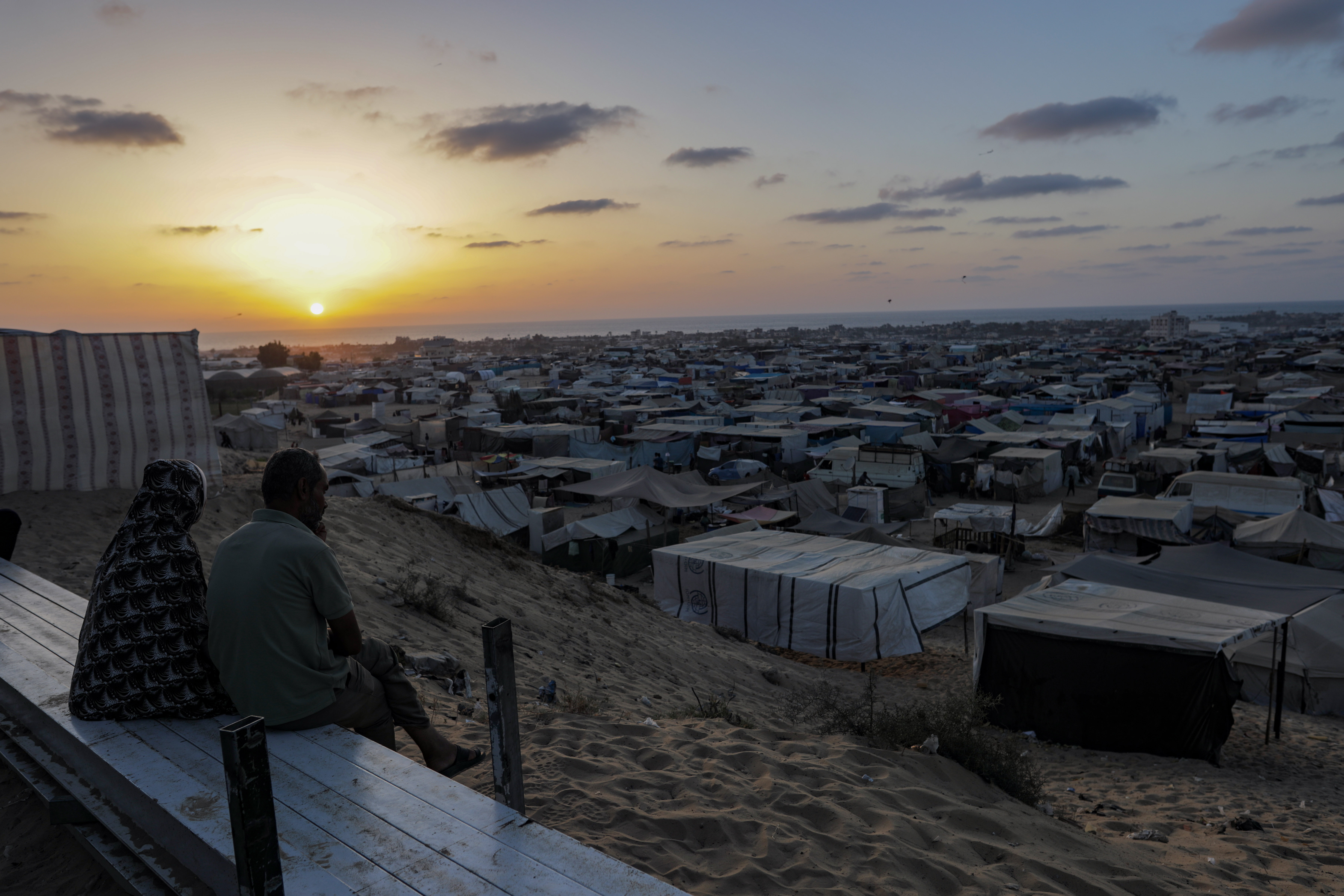 Palestinians watch the sunset at the Khan Younis camp in southern Gaza. 