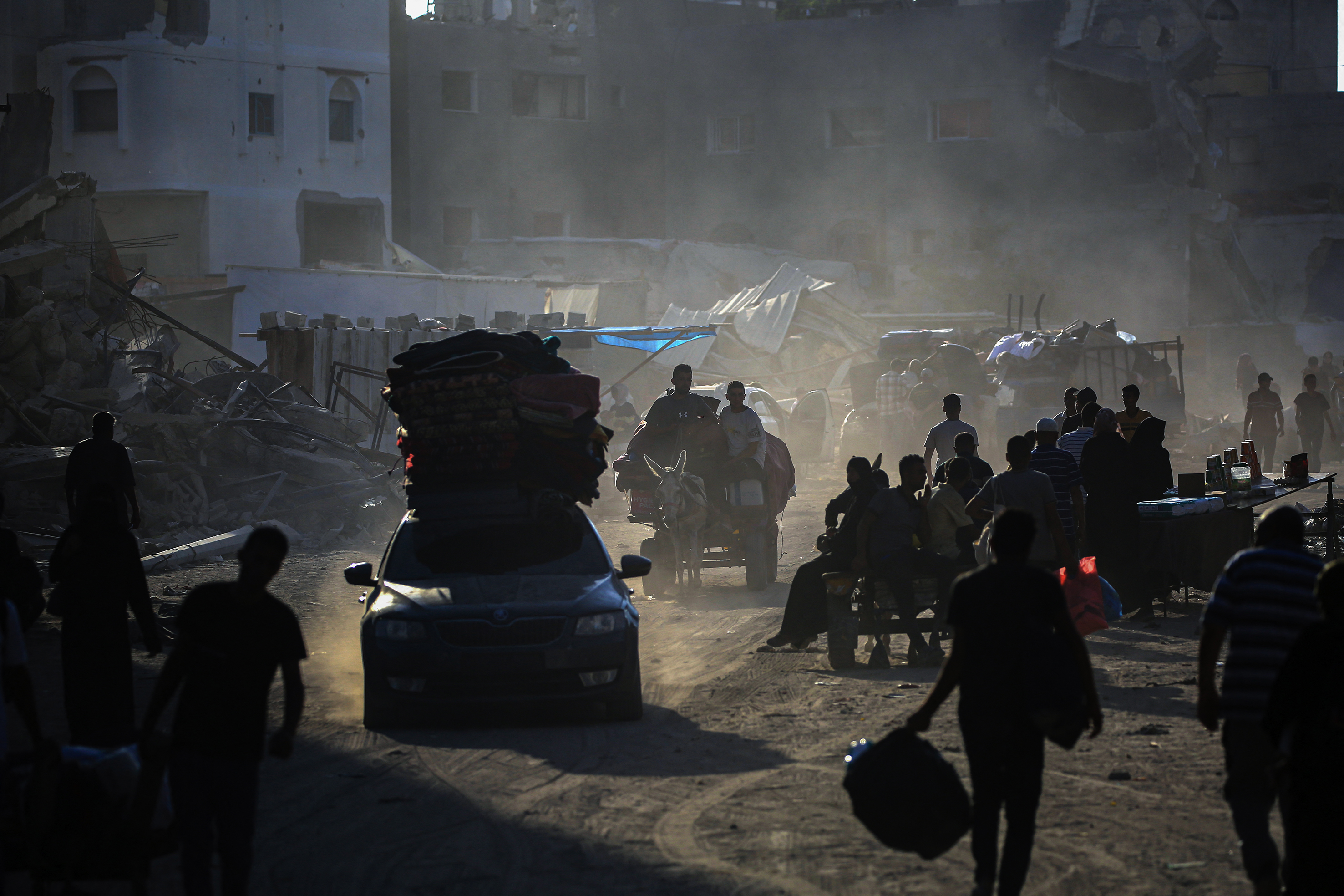 Displaced Palestinians flee areas of east Khan Younis after the Israeli army issued a new evacuation order.