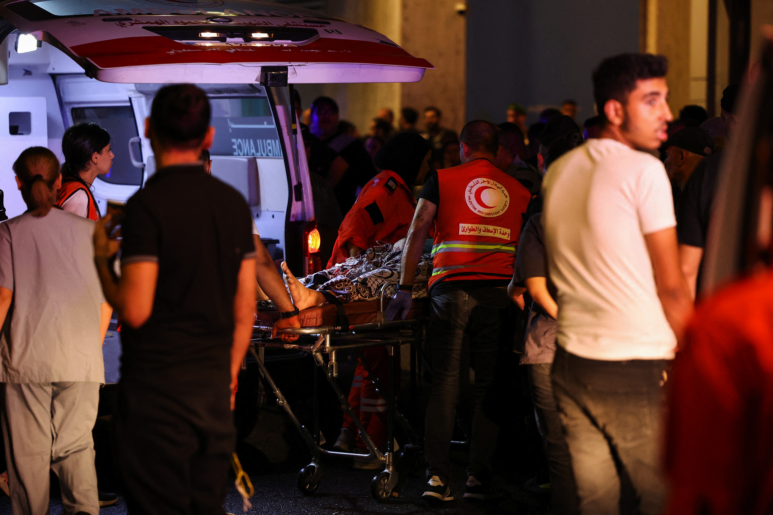 A person is carried on a stretcher outside American University of Beirut Medical Center.