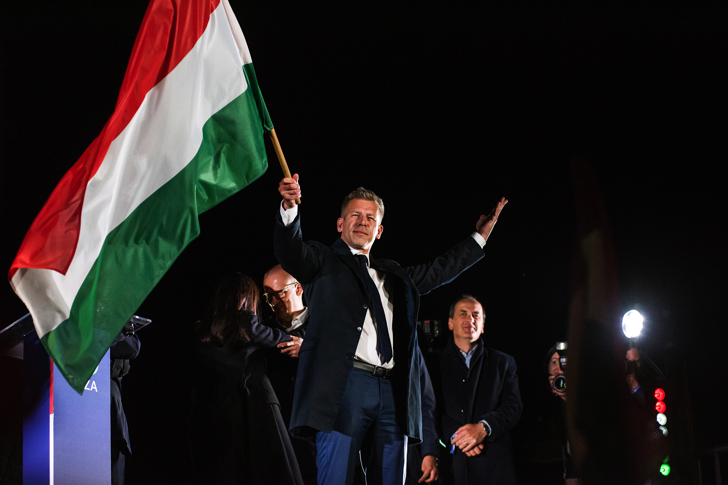 Péter Magyar waves the Hungarian flag on election night in Budapest.