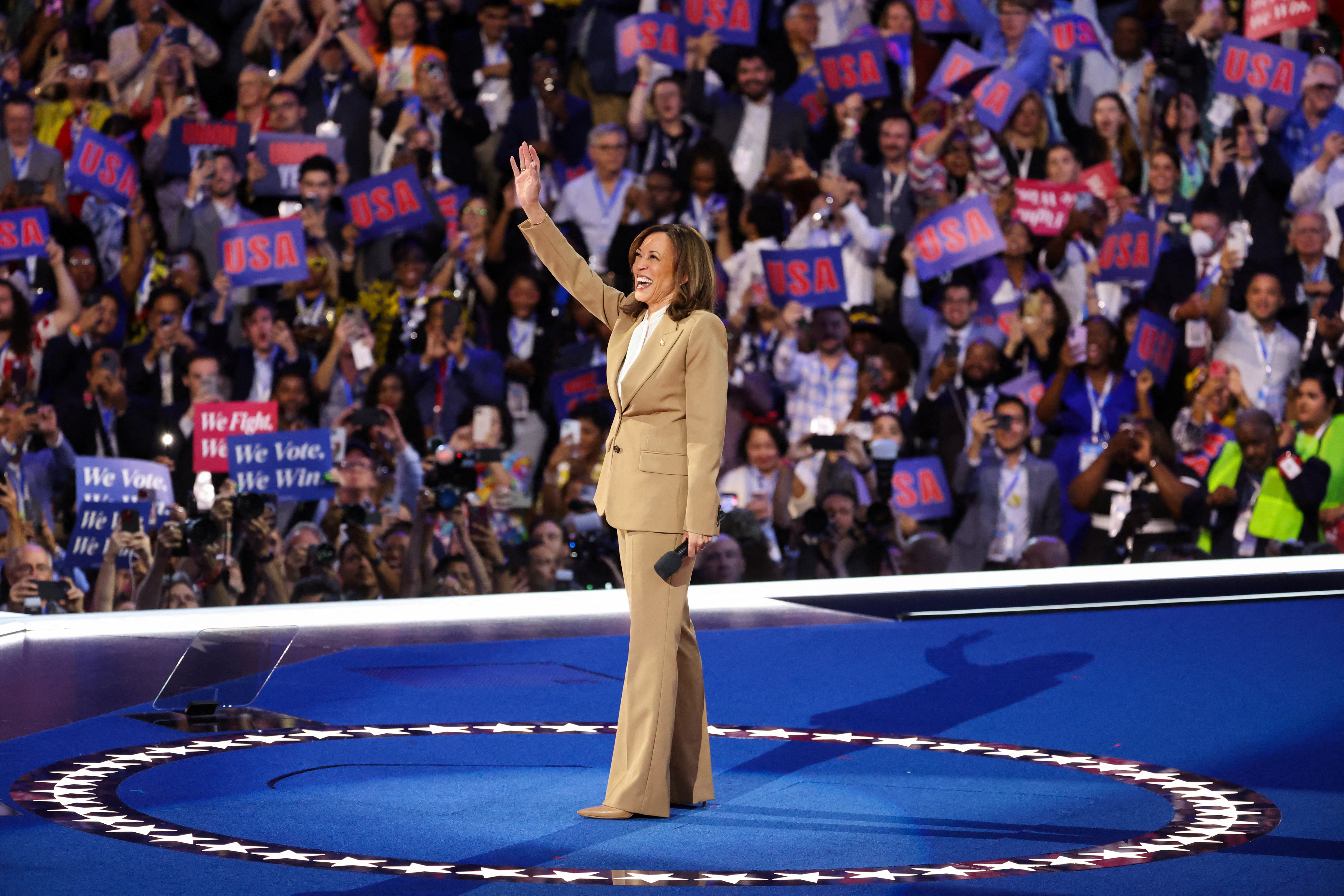 Kamala Harris on stage with a microphone.
