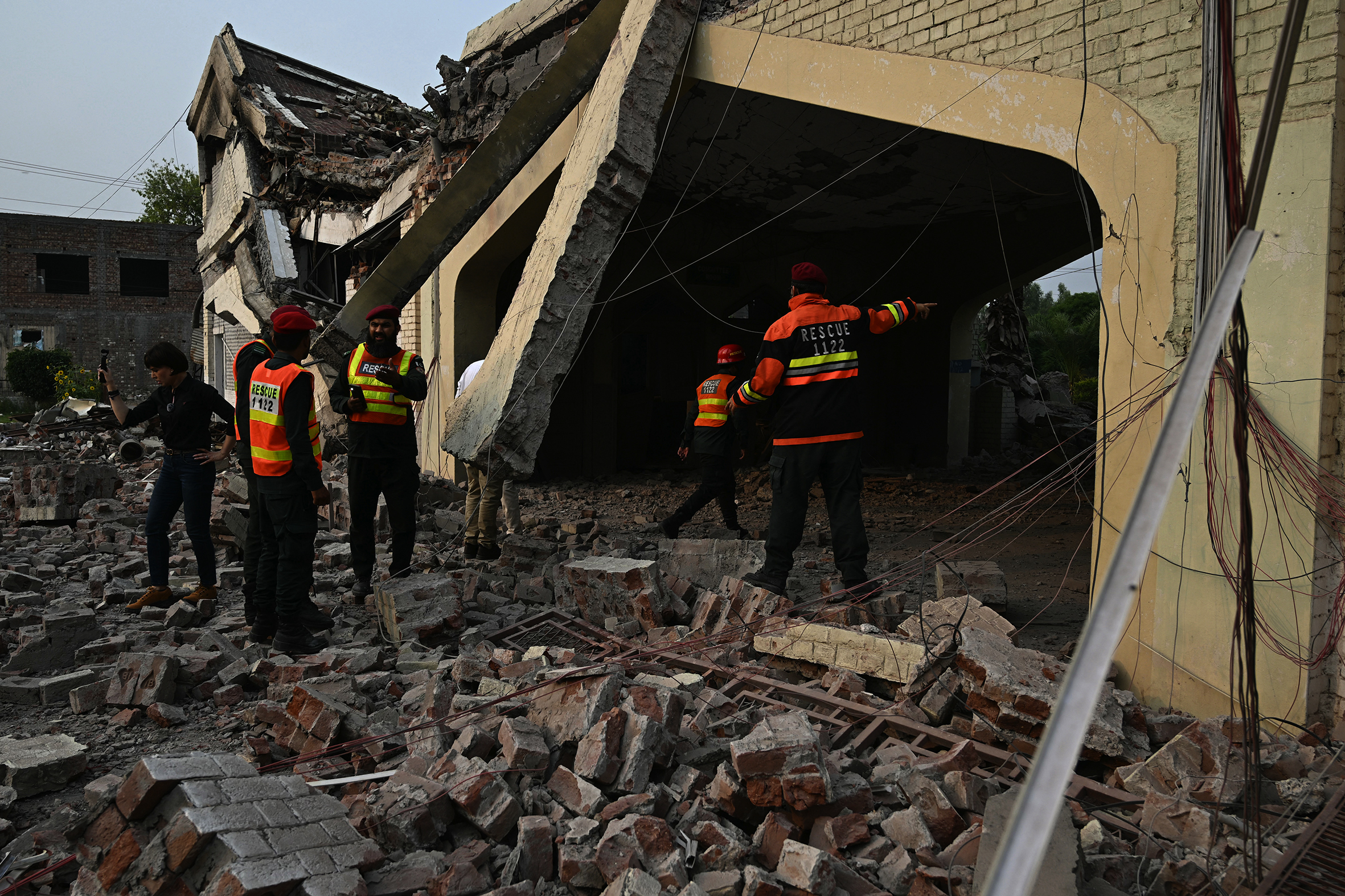 Rescue workers inspect damage caused by Indian air strikes to a building.