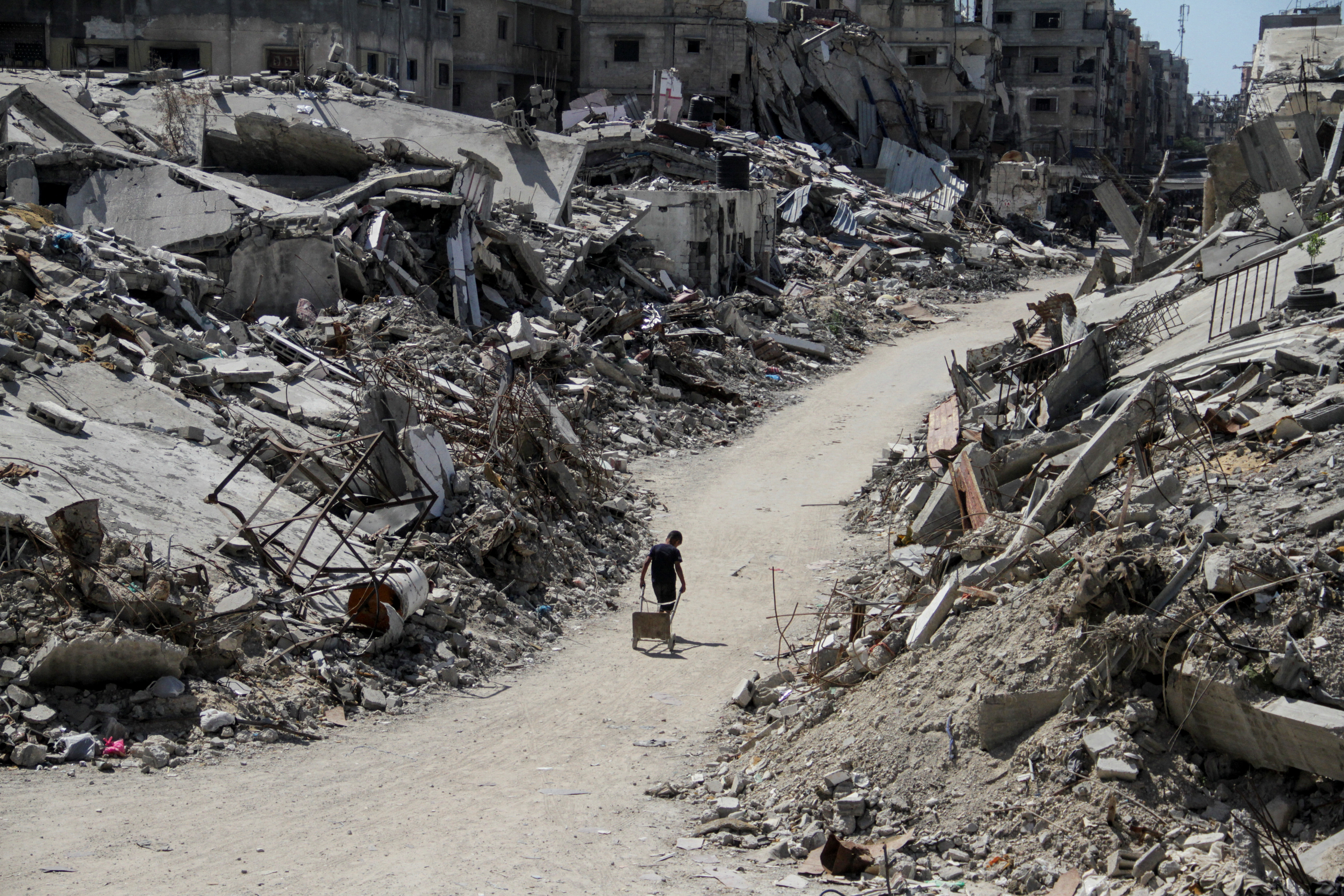 A young Palestinian boy walks amid the rubble of damaged buildings in Beit Lahia, northern Gaza, this week. 