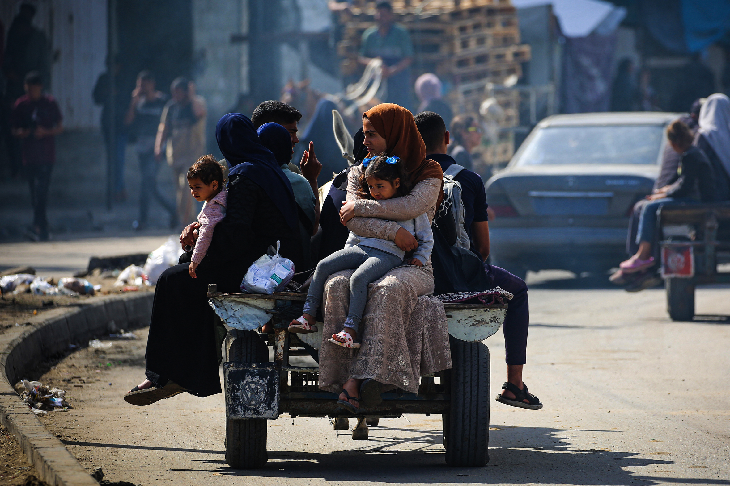 Displaced Palestinians travel on a cart in Rafah.