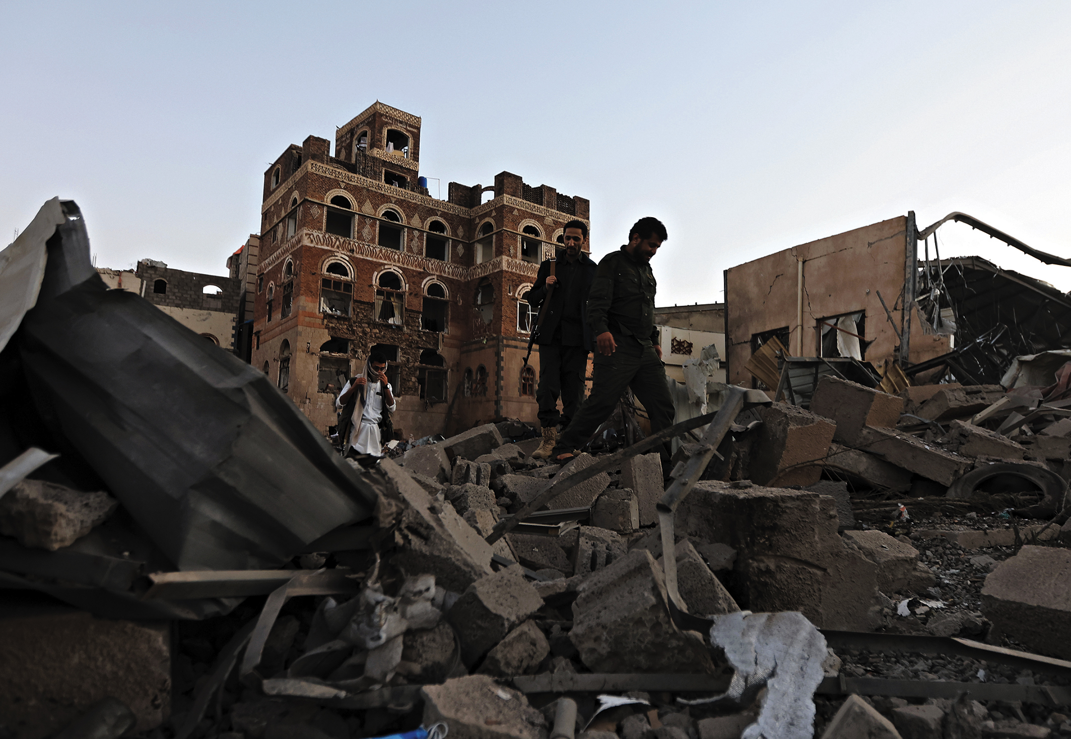 Houthi soldiers inspect damage to buildings after US air strikes in Sana’a, Yemen.