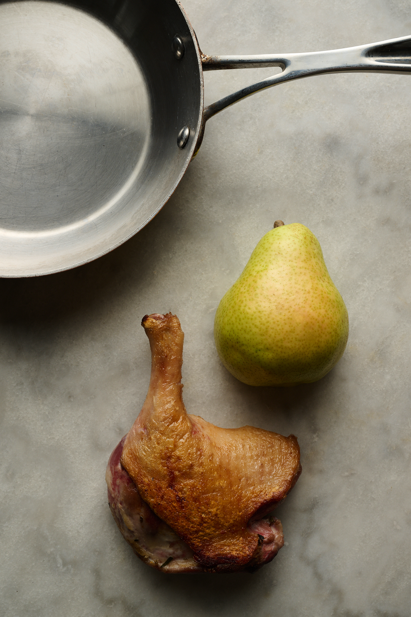 Crispy-skinned duck legs with chestnuts, baked pear and potatoes boulangère