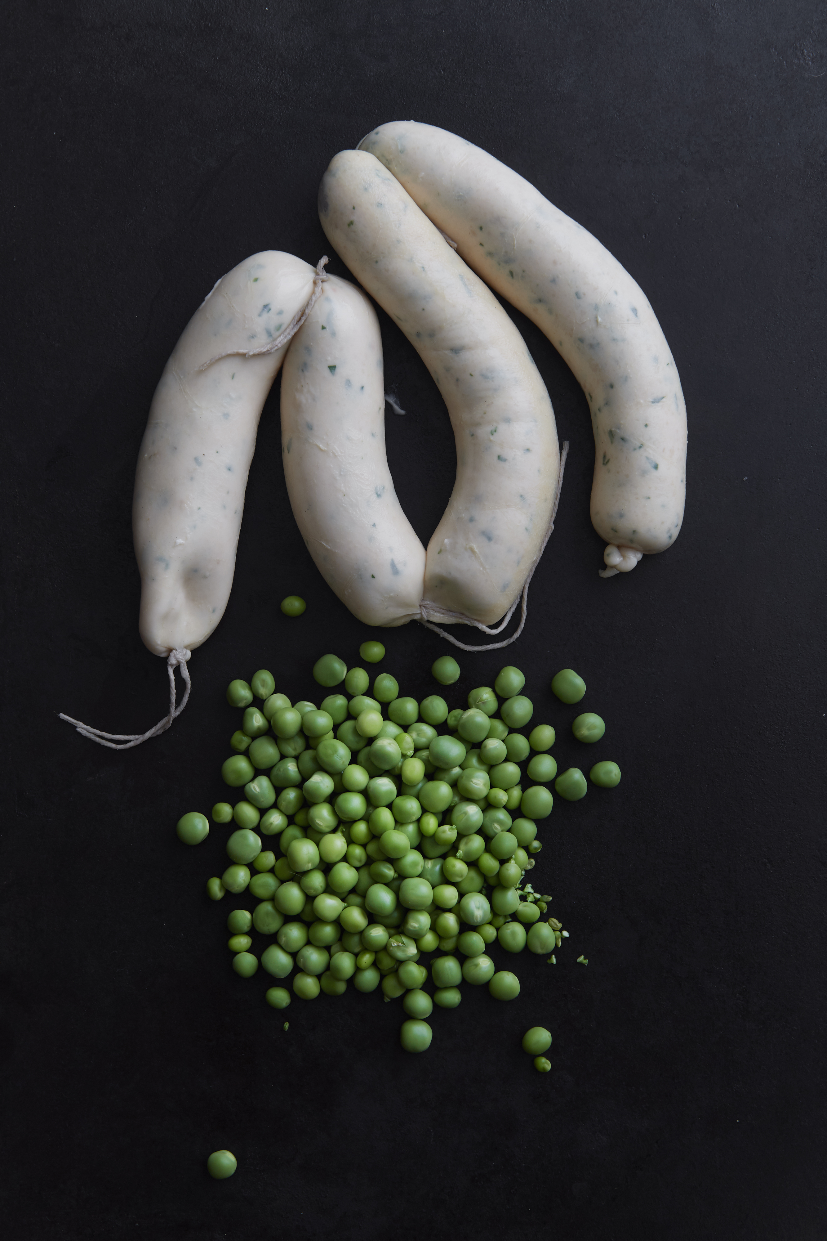 Chicken mousseline sausages with petits pois à la française