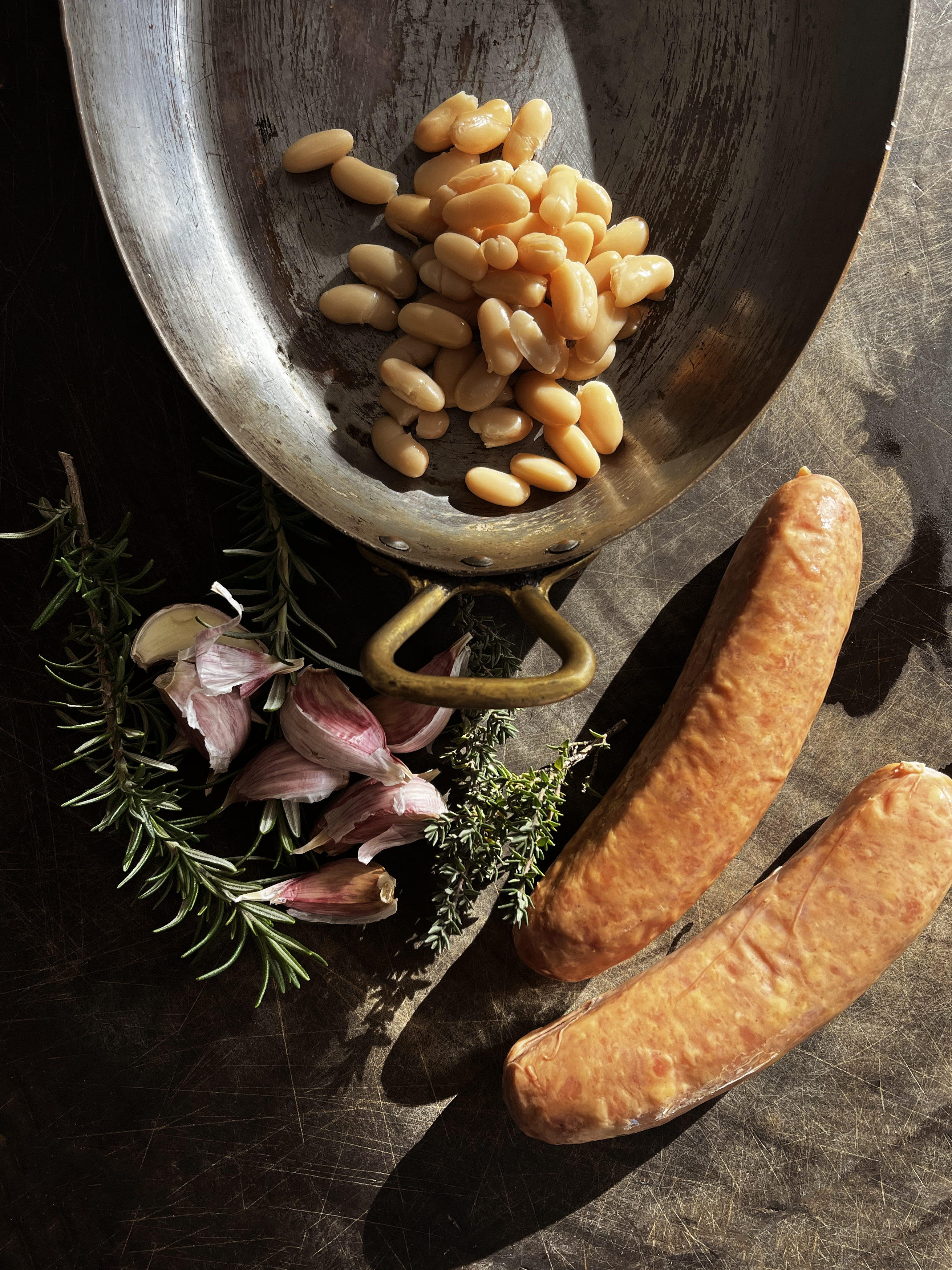 Two sausages, beans and garlic.