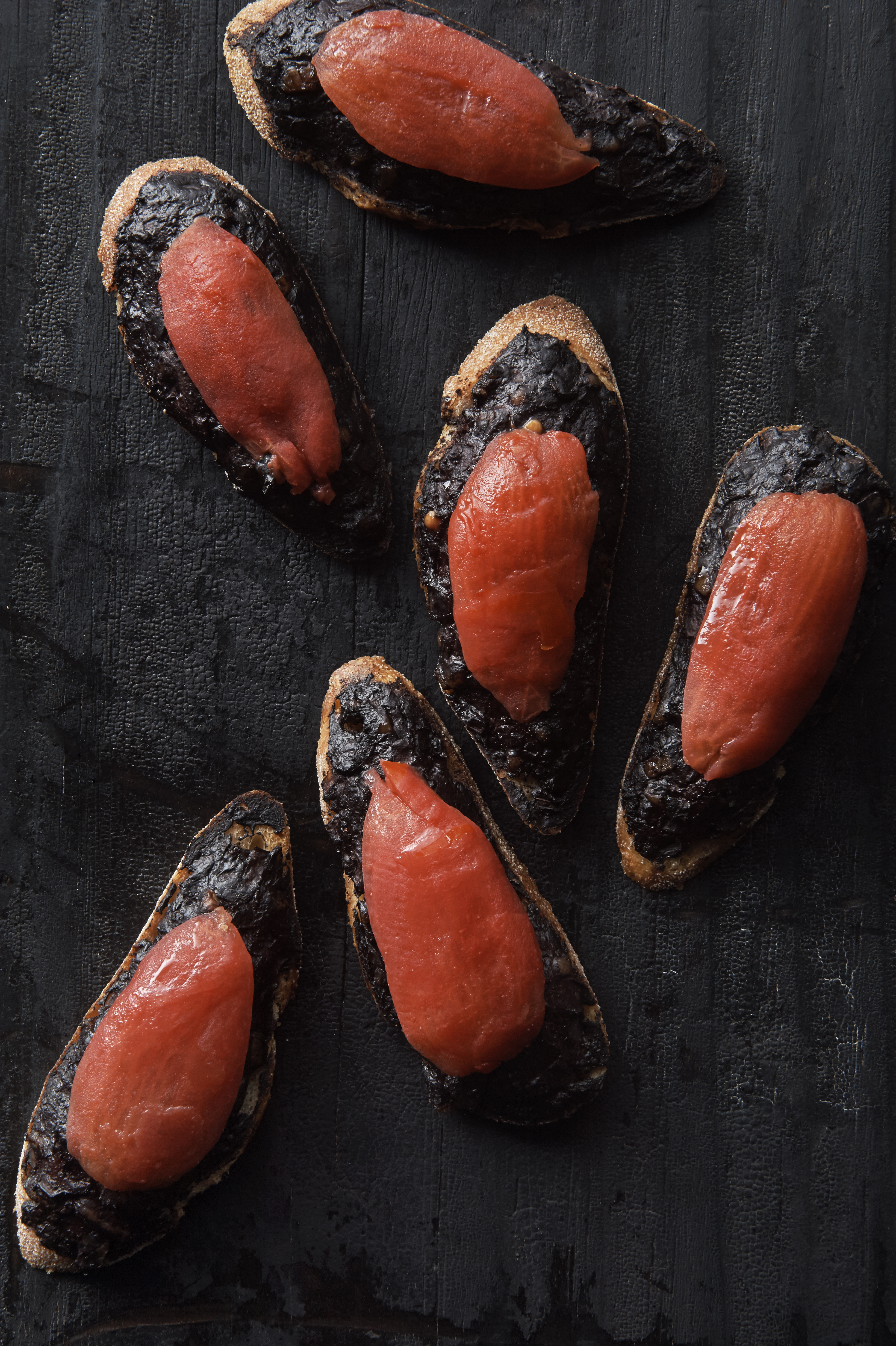 Boudin noir on toast with smoked tomato and parsley salad