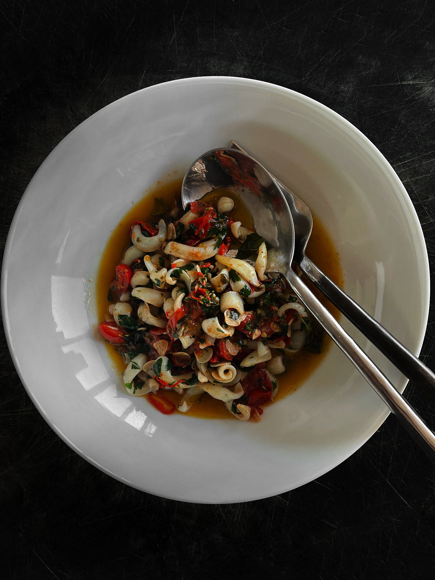 Calamari with garlic, chilli, lemon and tomato