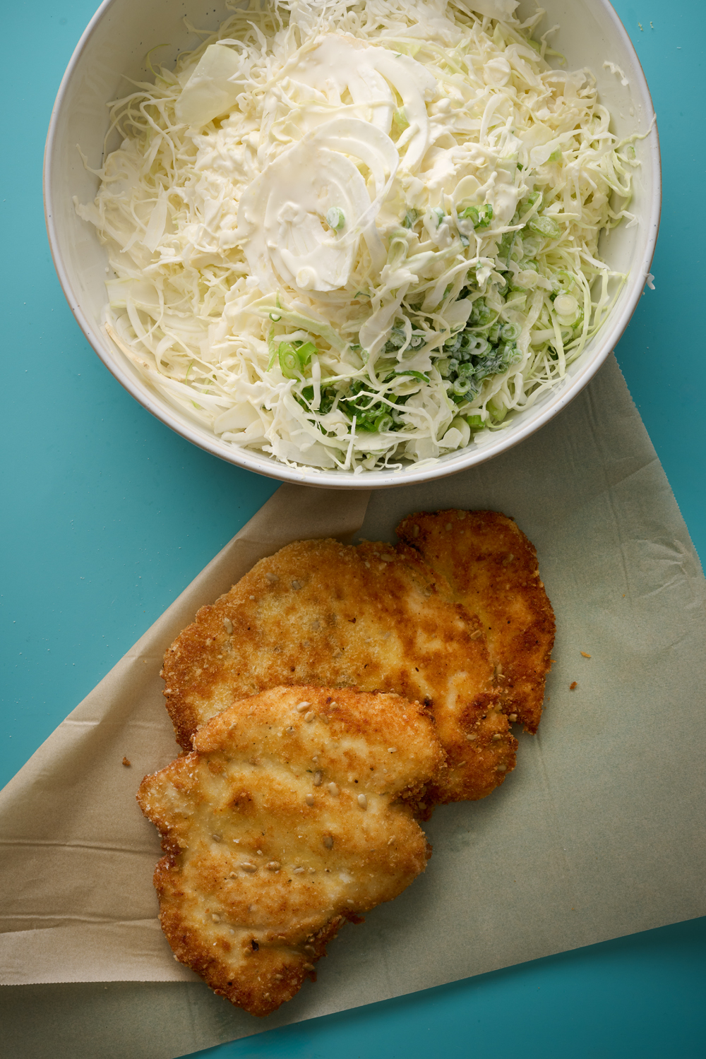 Chicken schnitzel with seed and parmesan crumb and white slaw