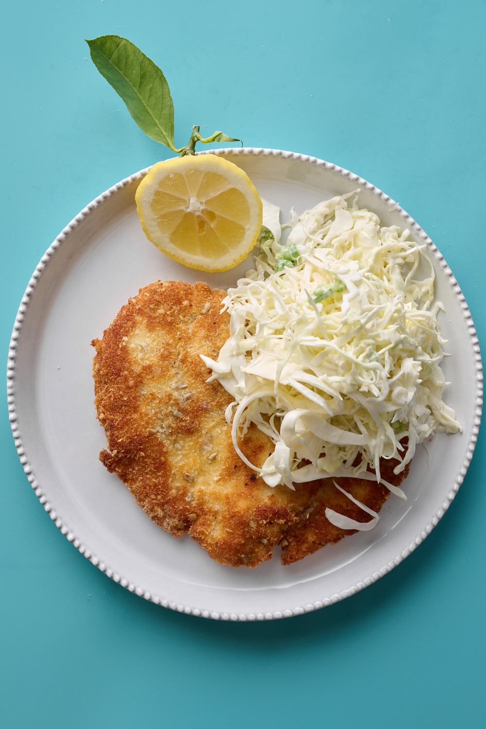 Chicken schnitzel with seed and parmesan crumb and white slaw