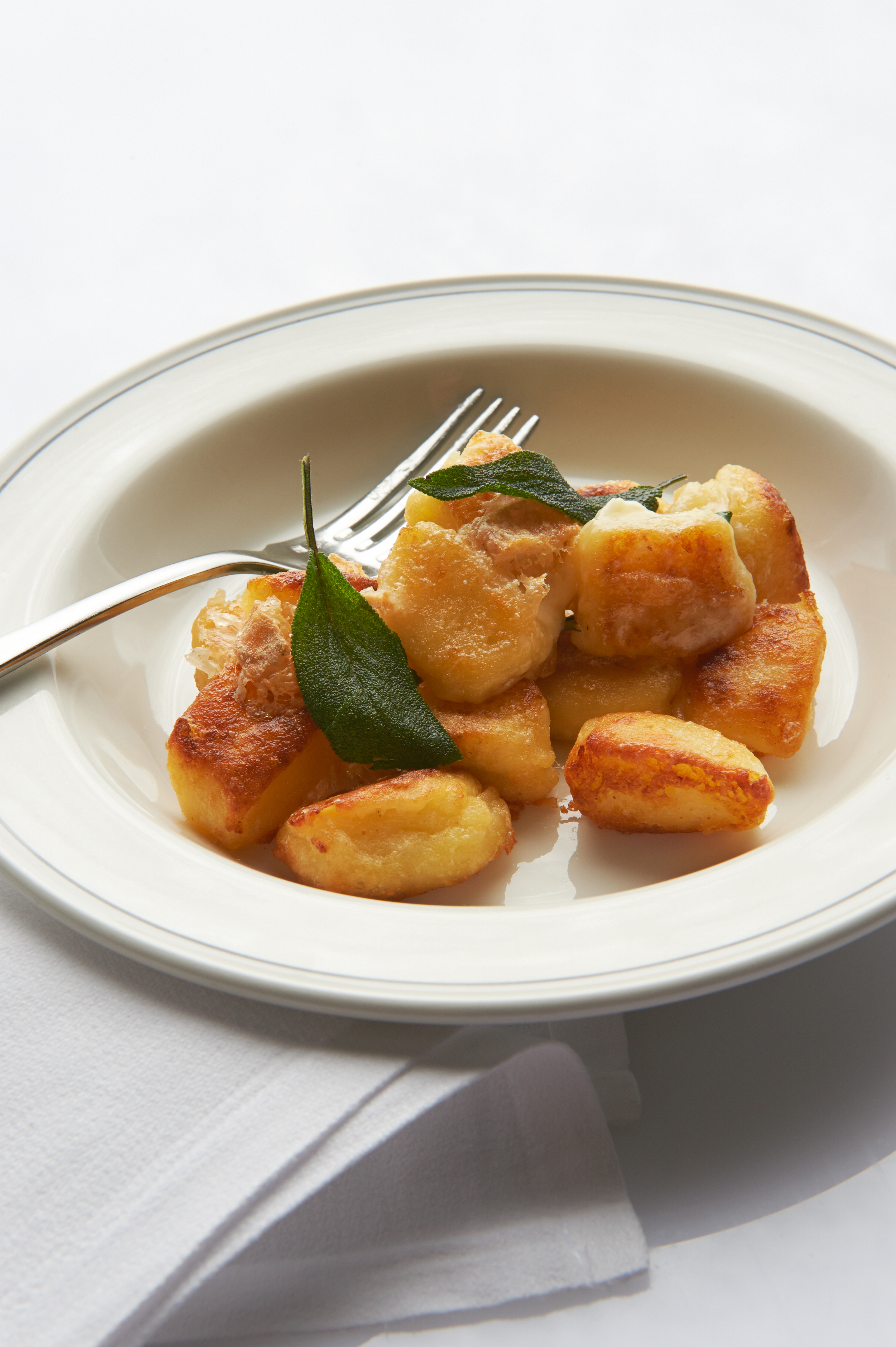 Baked gnocchi and potato and onion gratin