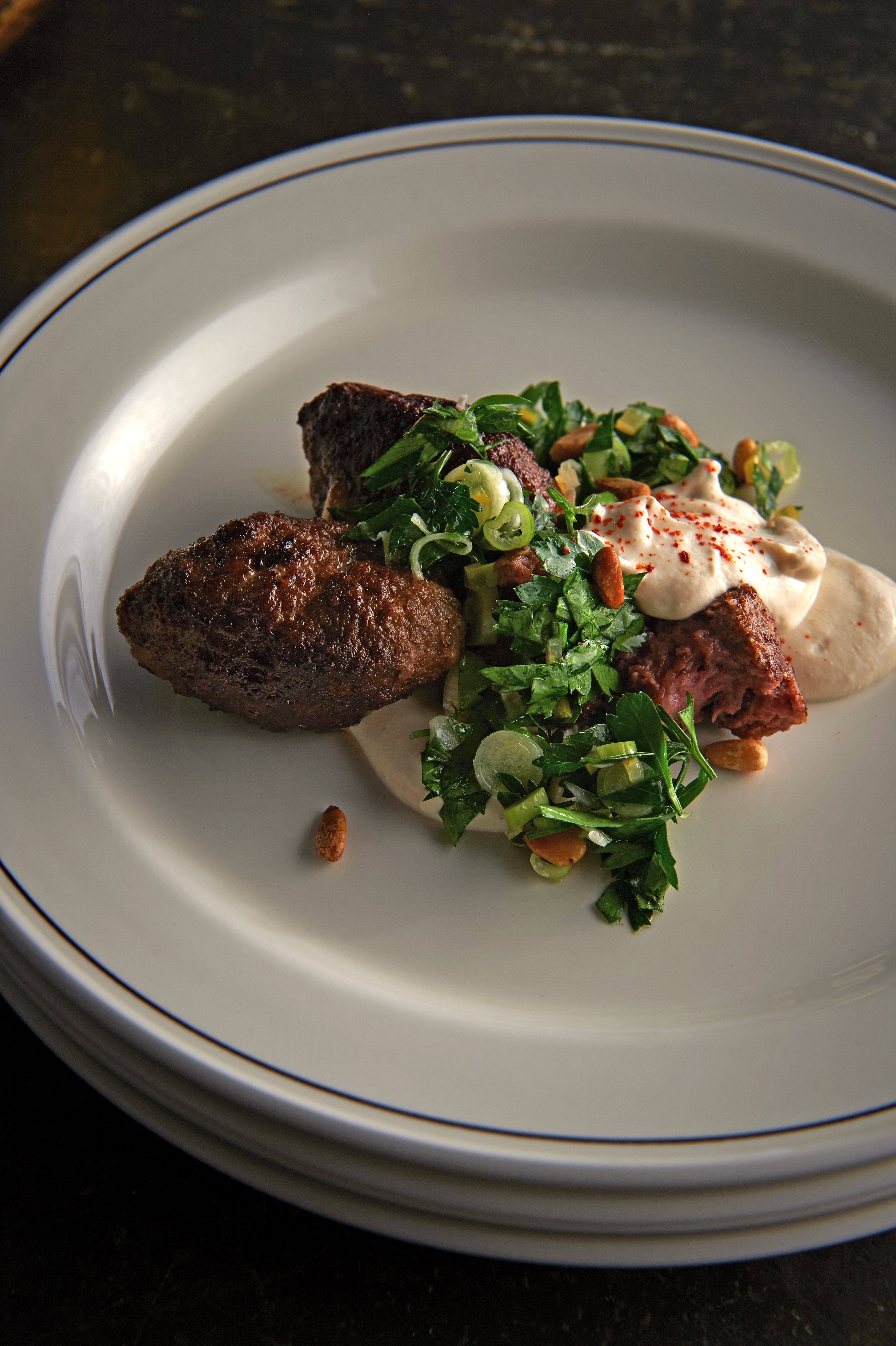 Merguez meatballs with yoghurt sauce and parsley salad