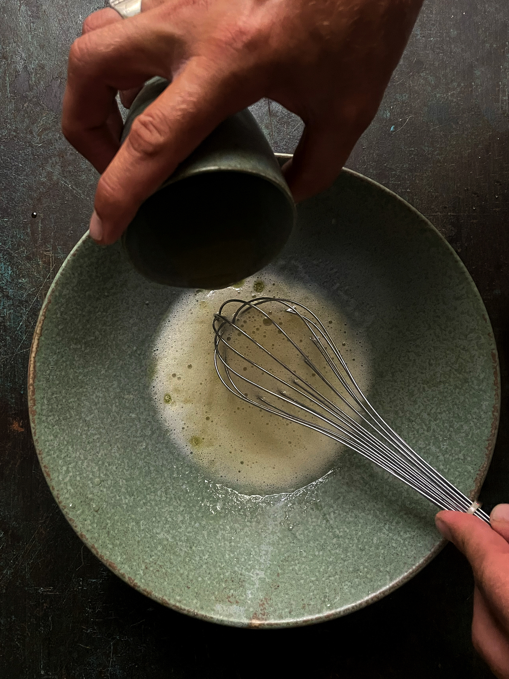 "Strain the liquid into a mixing bowl and gently begin drizzling the olive oil in while whisking to emulsify the liquid while it is still warm".