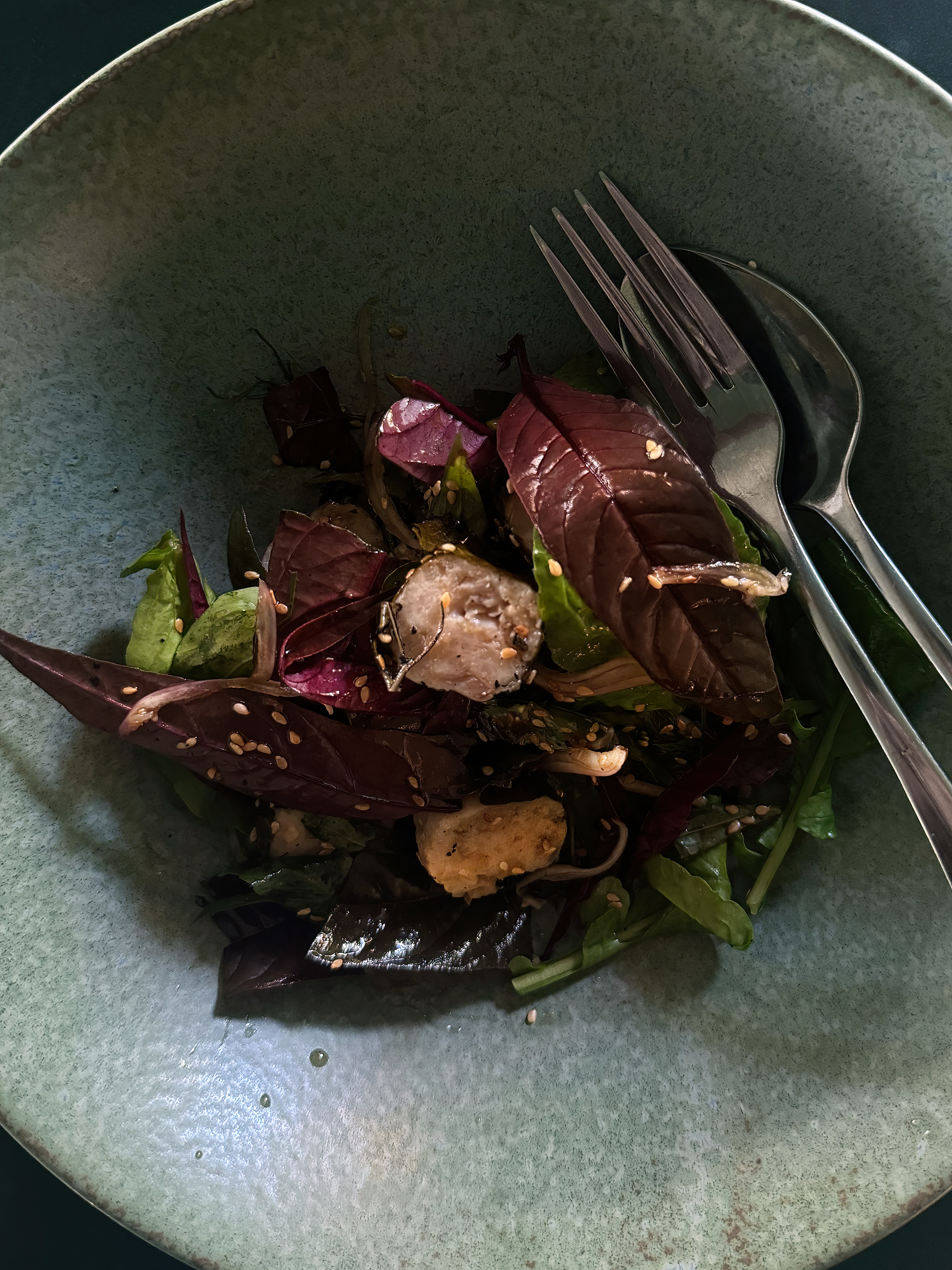 Vine leaf dumpling salad with bitter leaves, honey and thyme