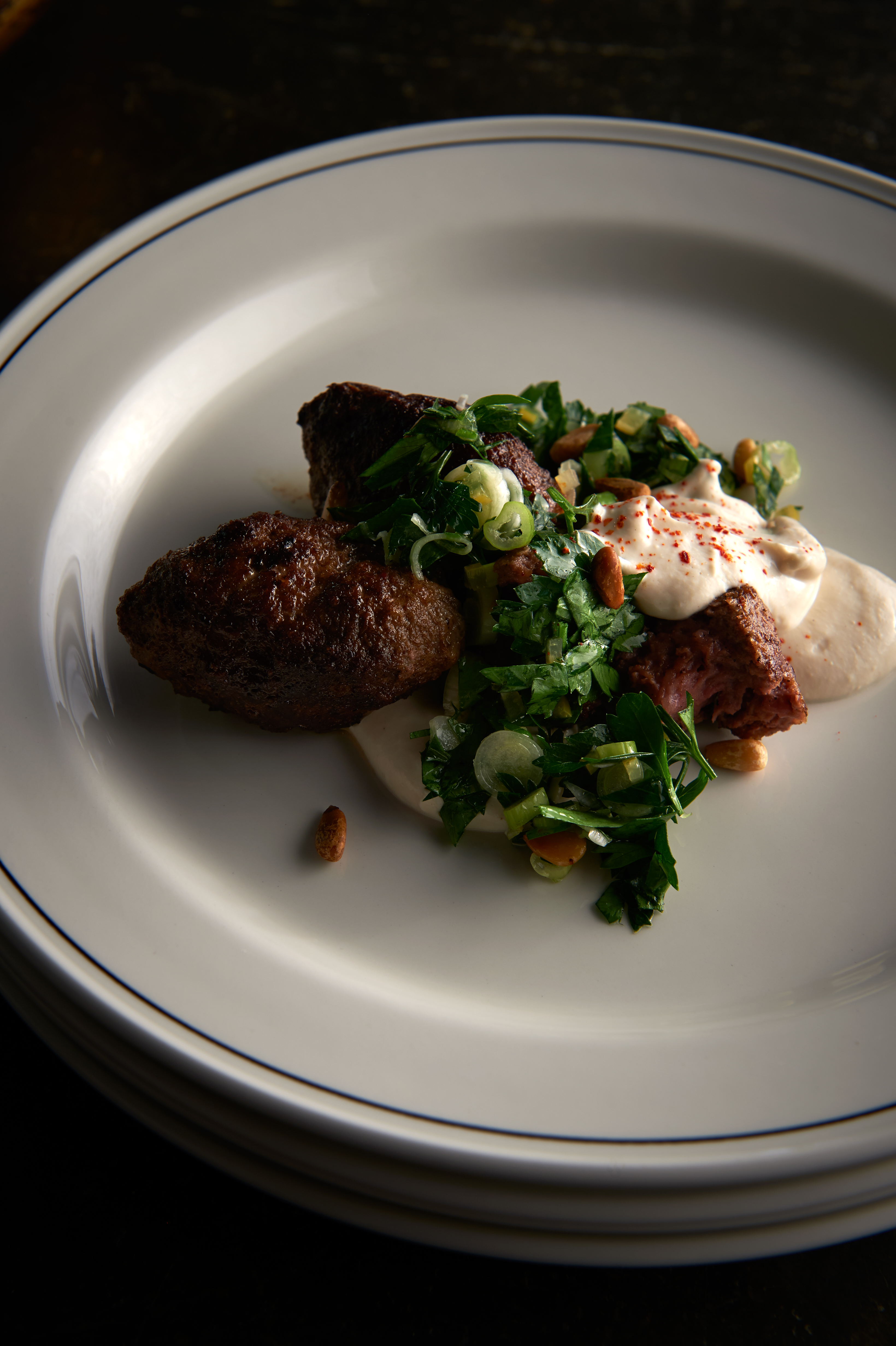 Mergeuz meatballs with yoghurt sauce and parsley salad