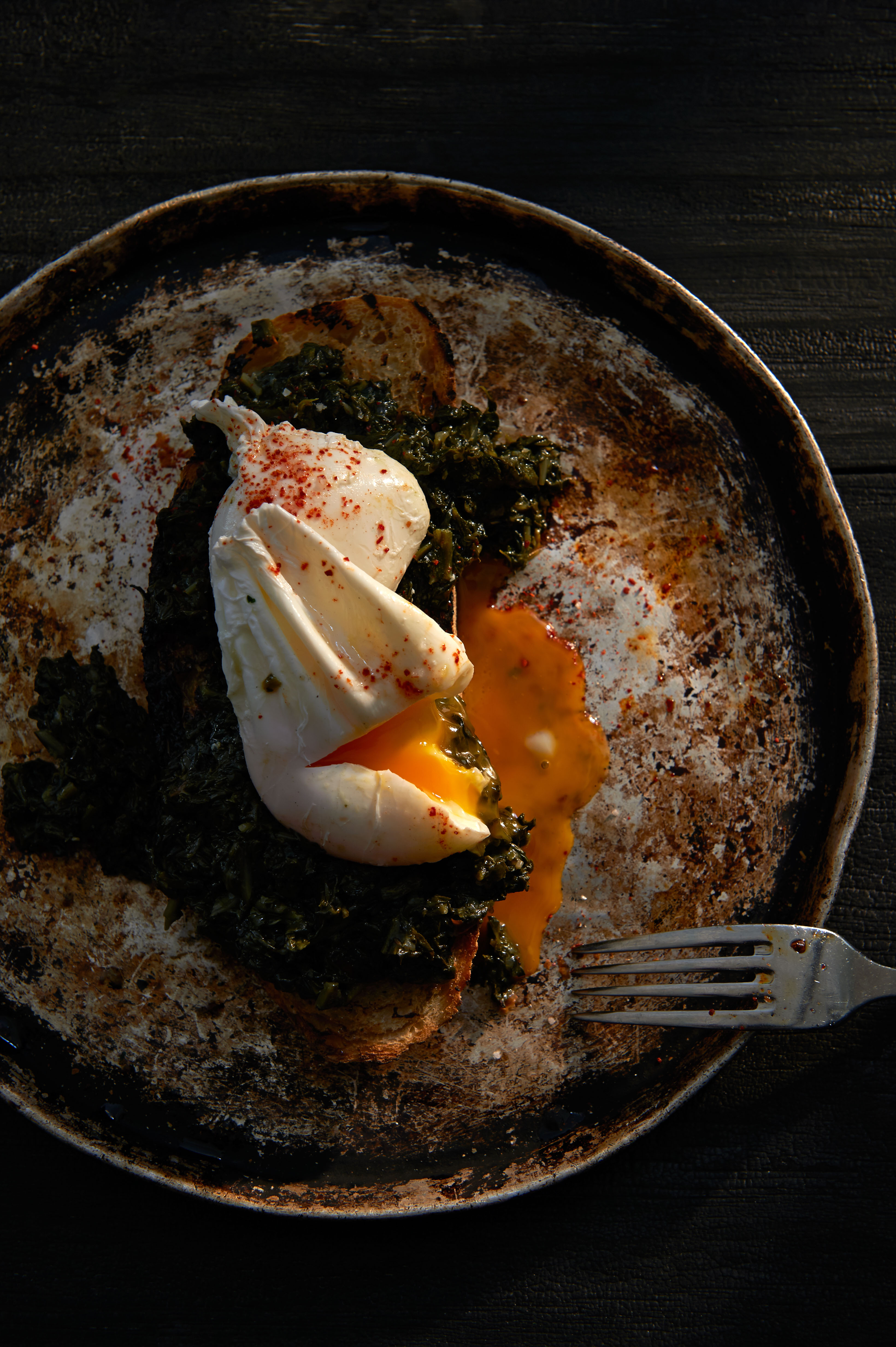 Wilted greens and poached eggs on toast