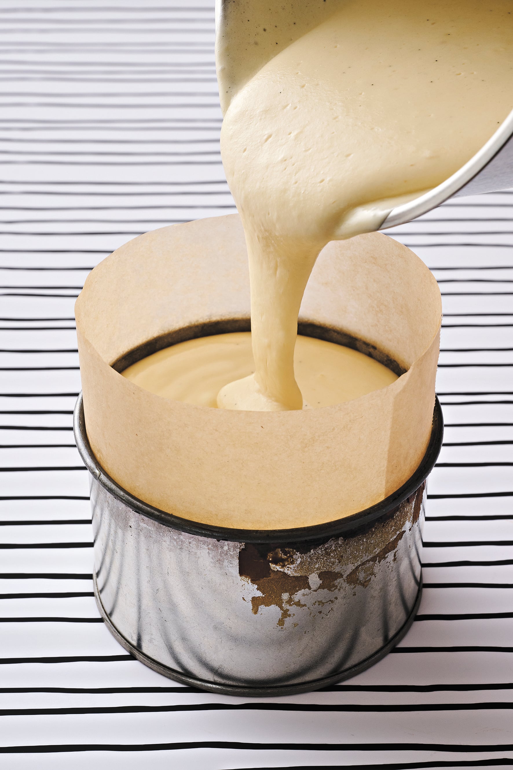 Cheesecake batter is poured into a tin