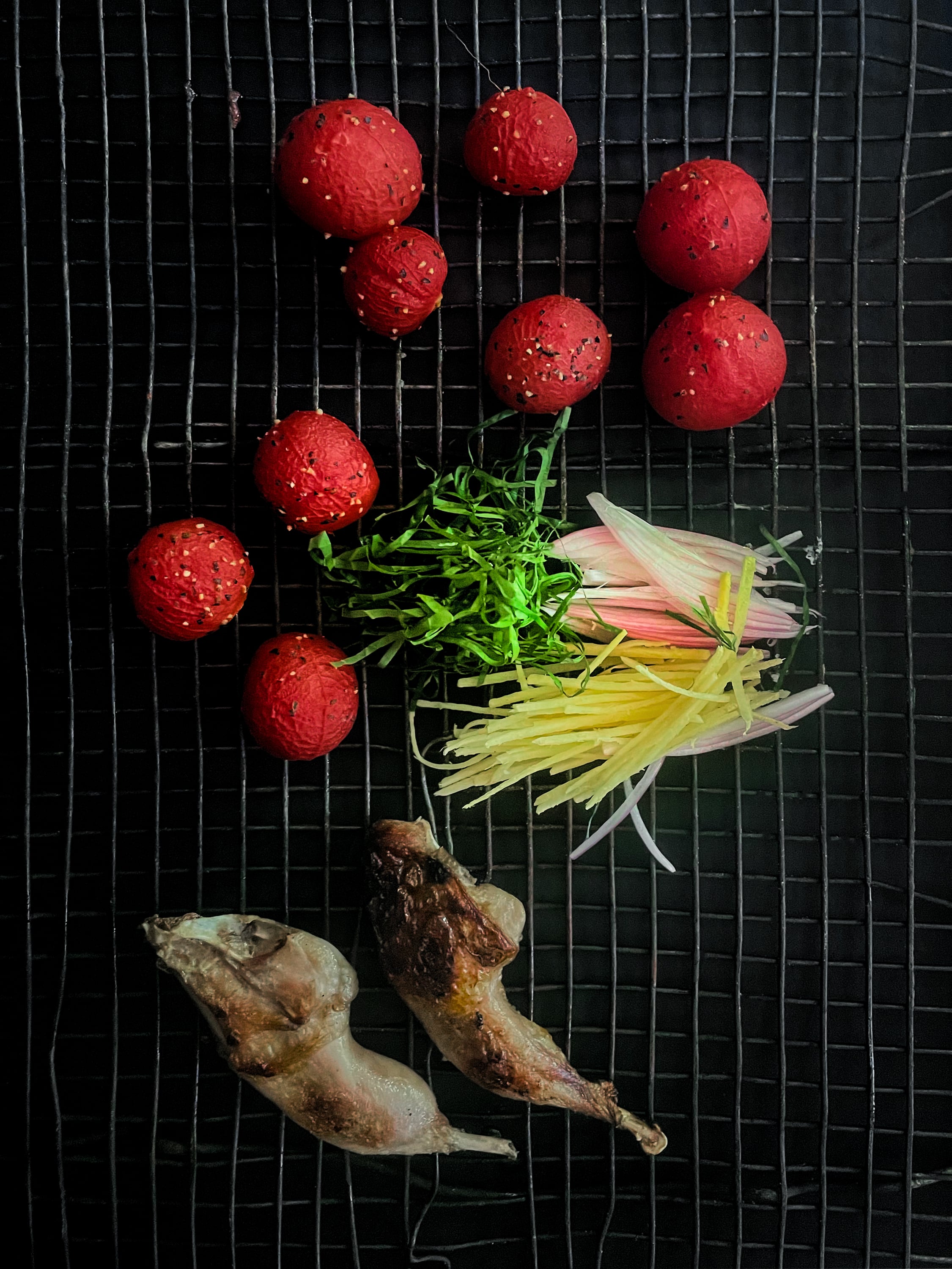 Grilled quail with dried tomato and betel leaves