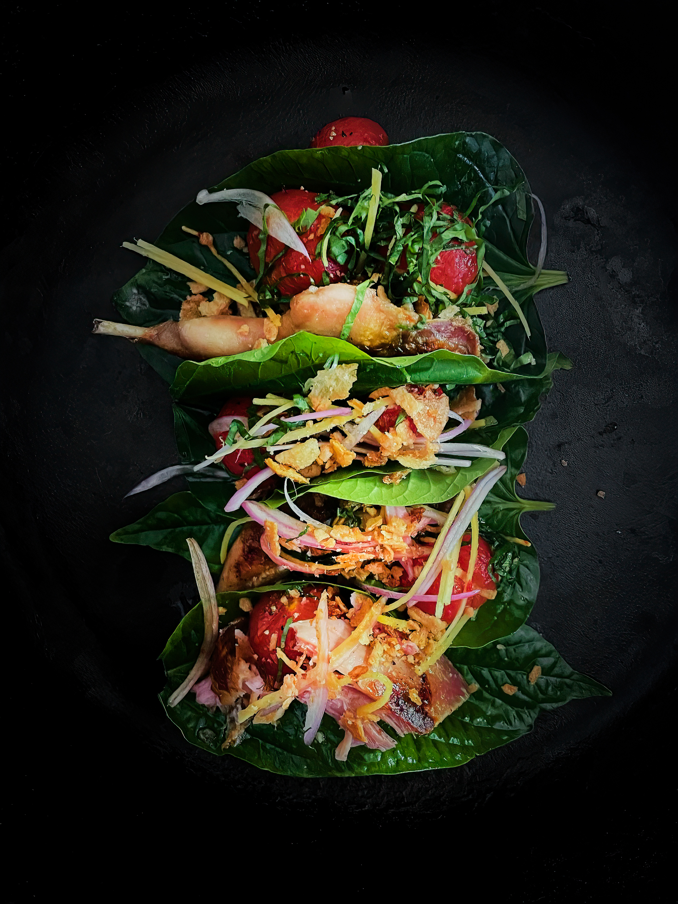 Grilled quail with dried tomato and betel leaves