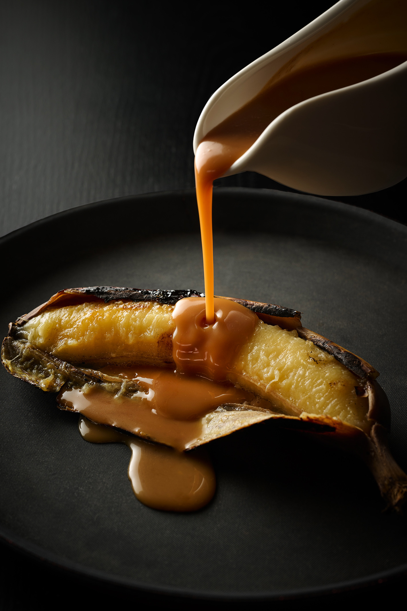 Grilled bananas with salted caramel sauce, vanilla ice-cream and peanuts