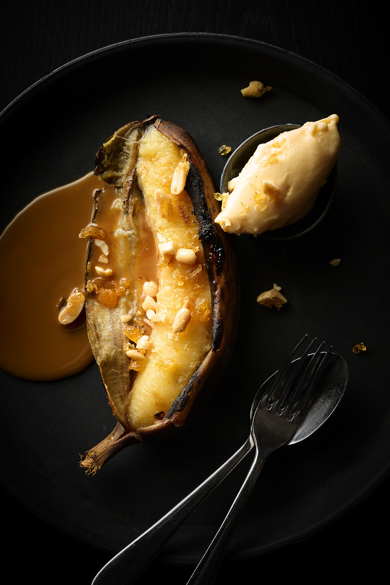 Grilled bananas with salted caramel sauce, vanilla ice-cream and peanuts