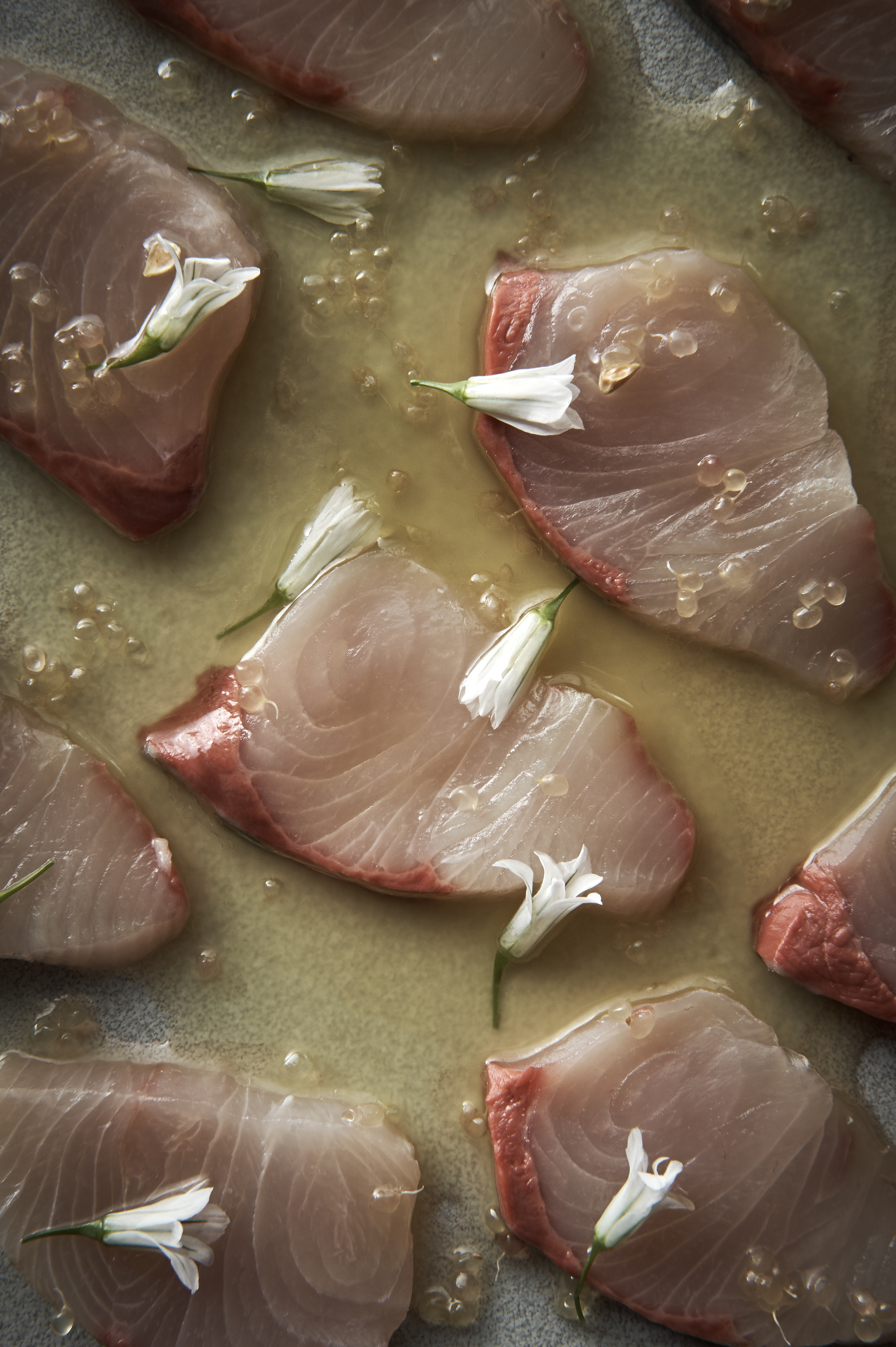 Raw kingfish with sweet ginger dressing and finger lime