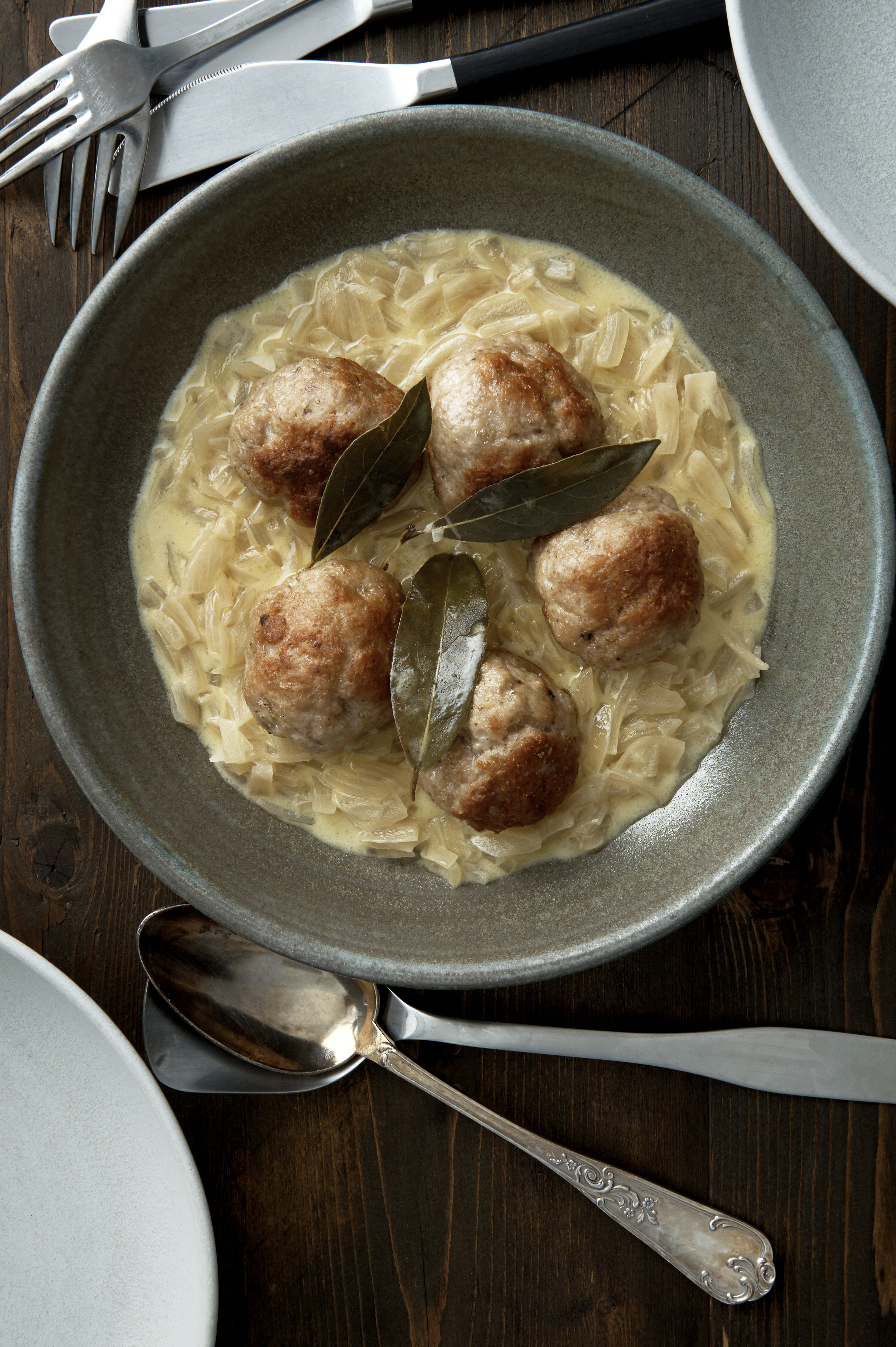 Spicy pork and fennel meatballs in onion sauce