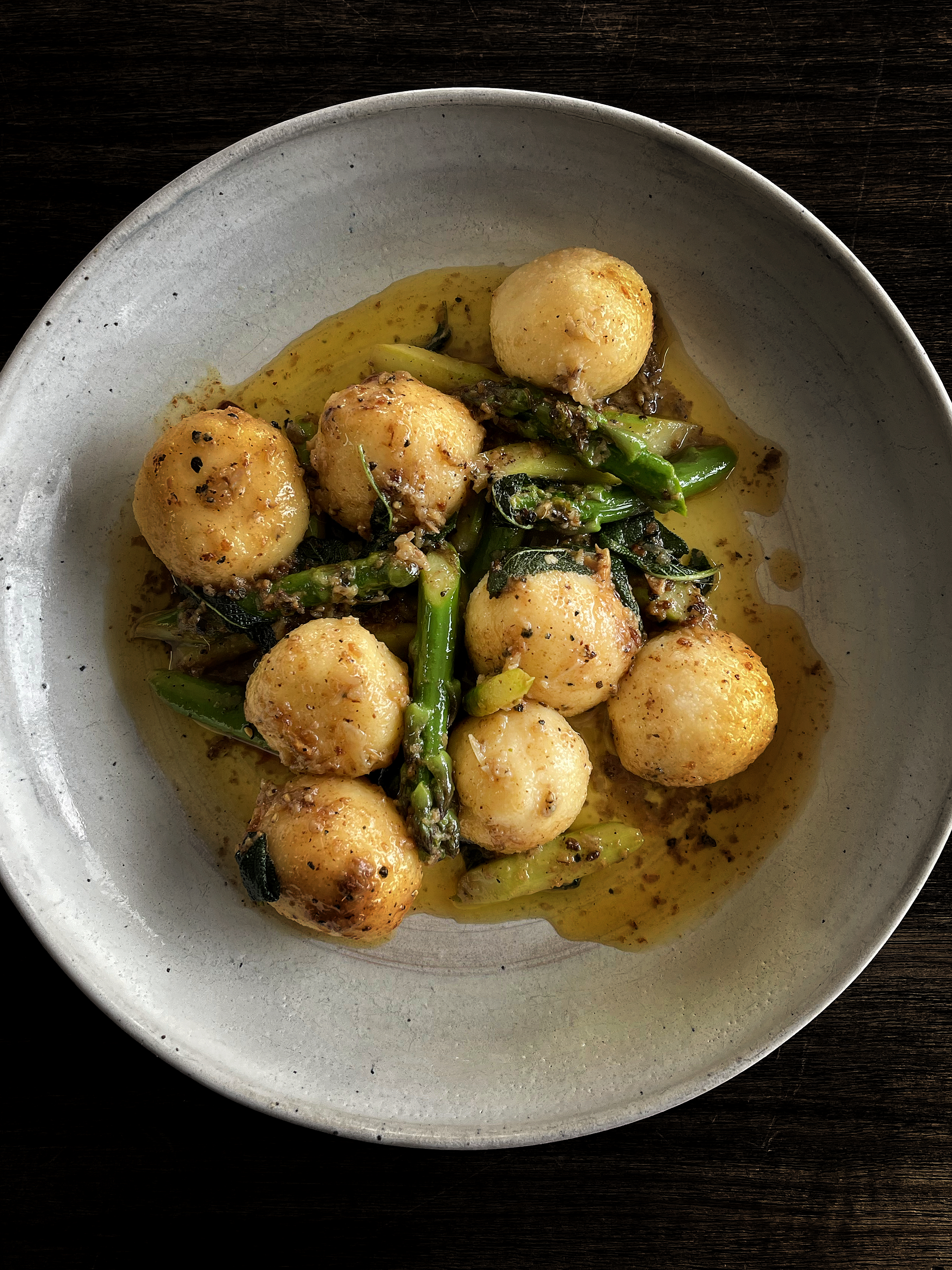 Ricotta gnudi with asparagus and anchovy