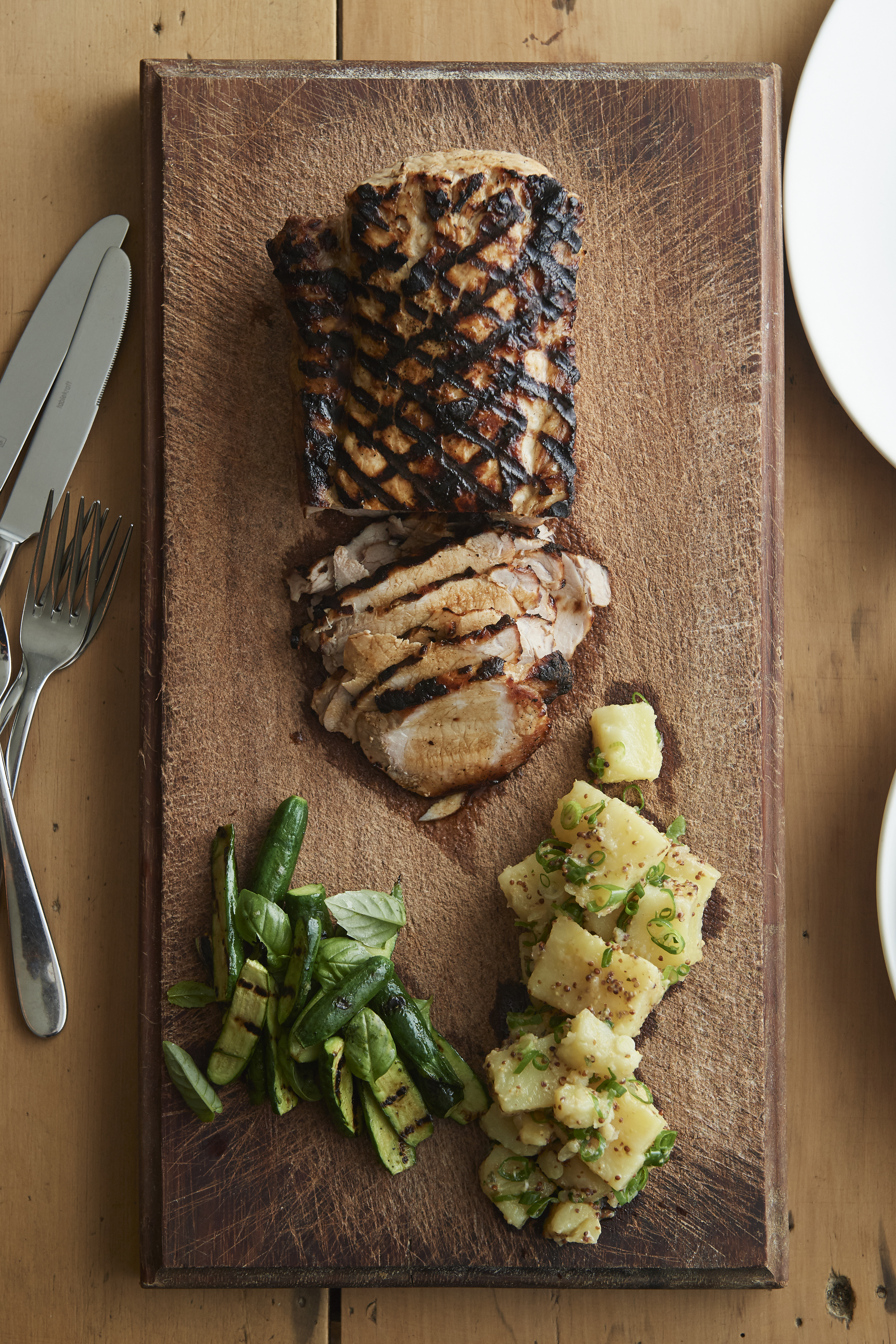 Barbecued brined pork loin with potato salad and grilled zucchini