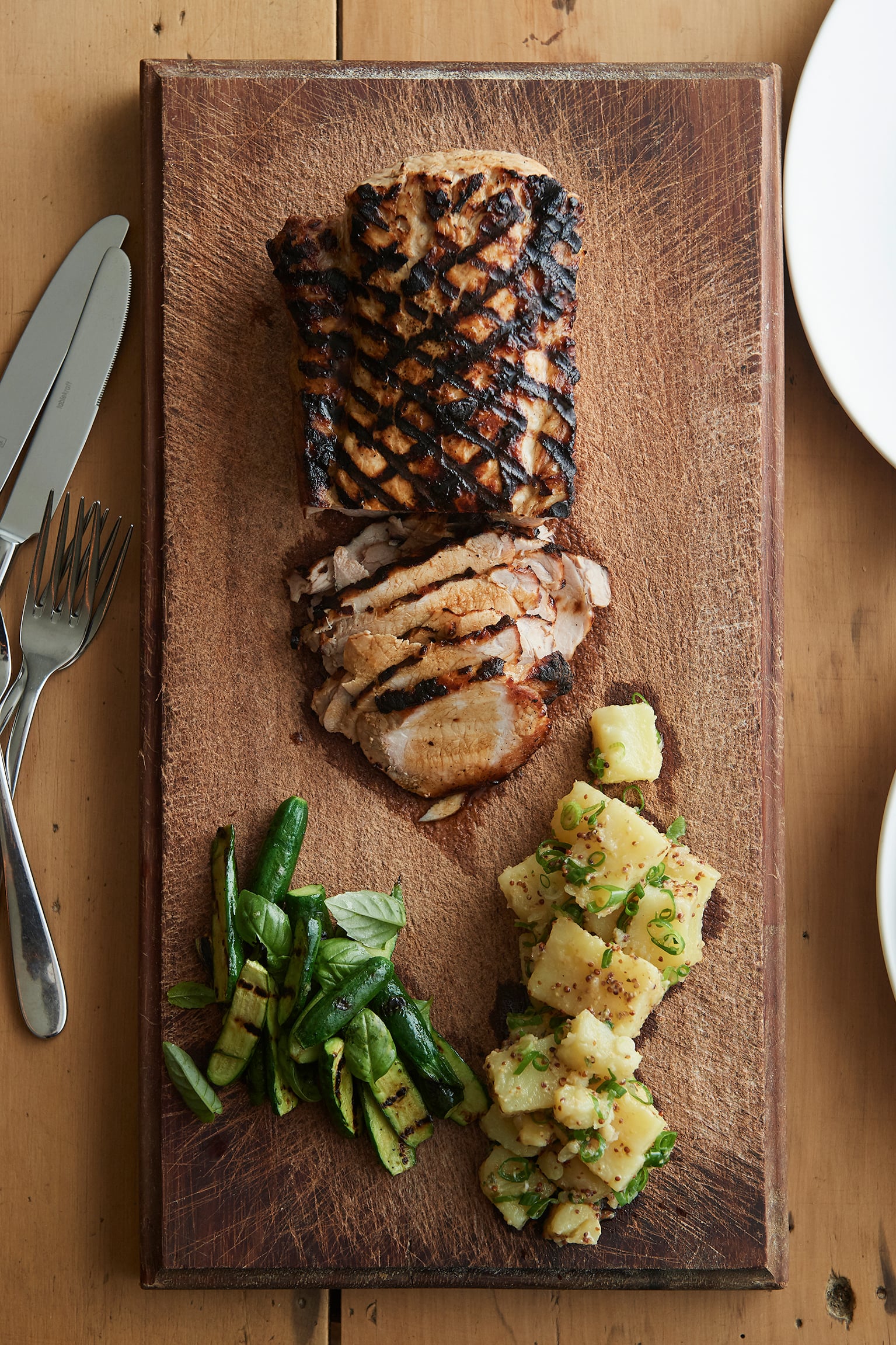 Barbecued brined pork loin with potato salad and grilled zucchini
